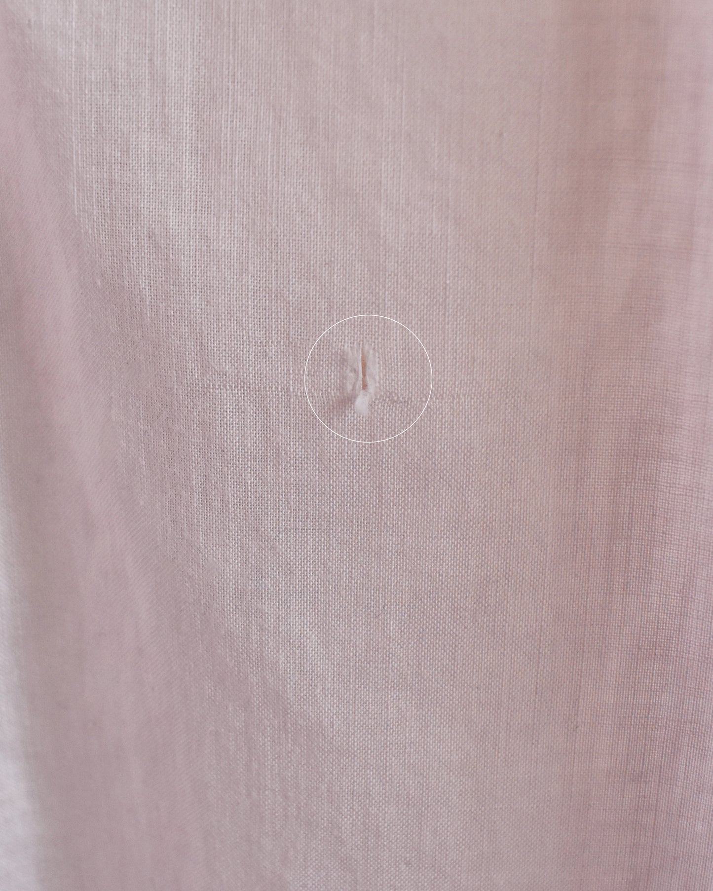close up of a small tear on the back of the skirt