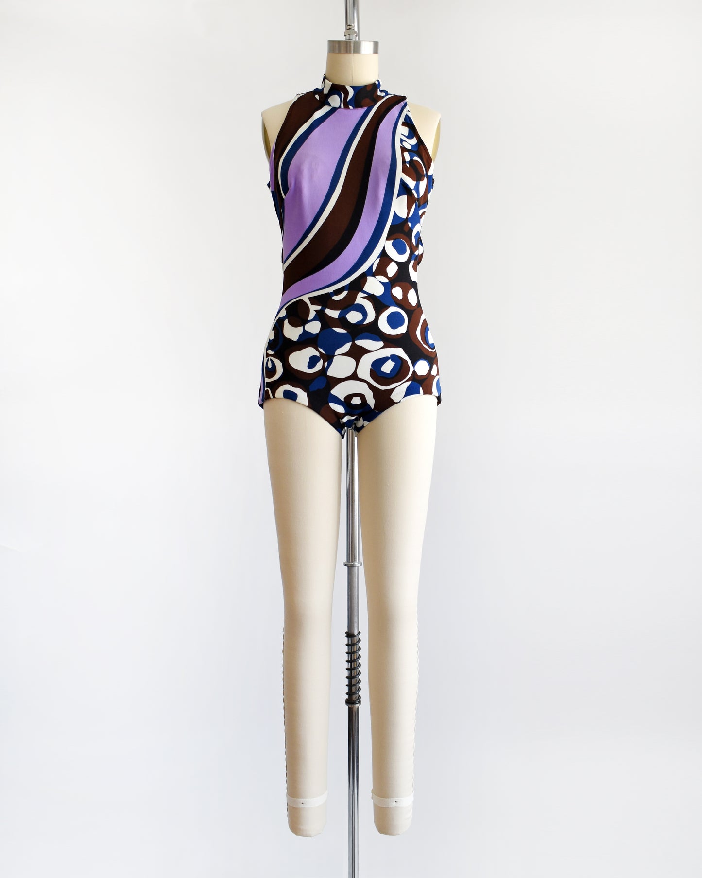 a vintage 1960s psychedelic swimsuit on a mannequin against a white background