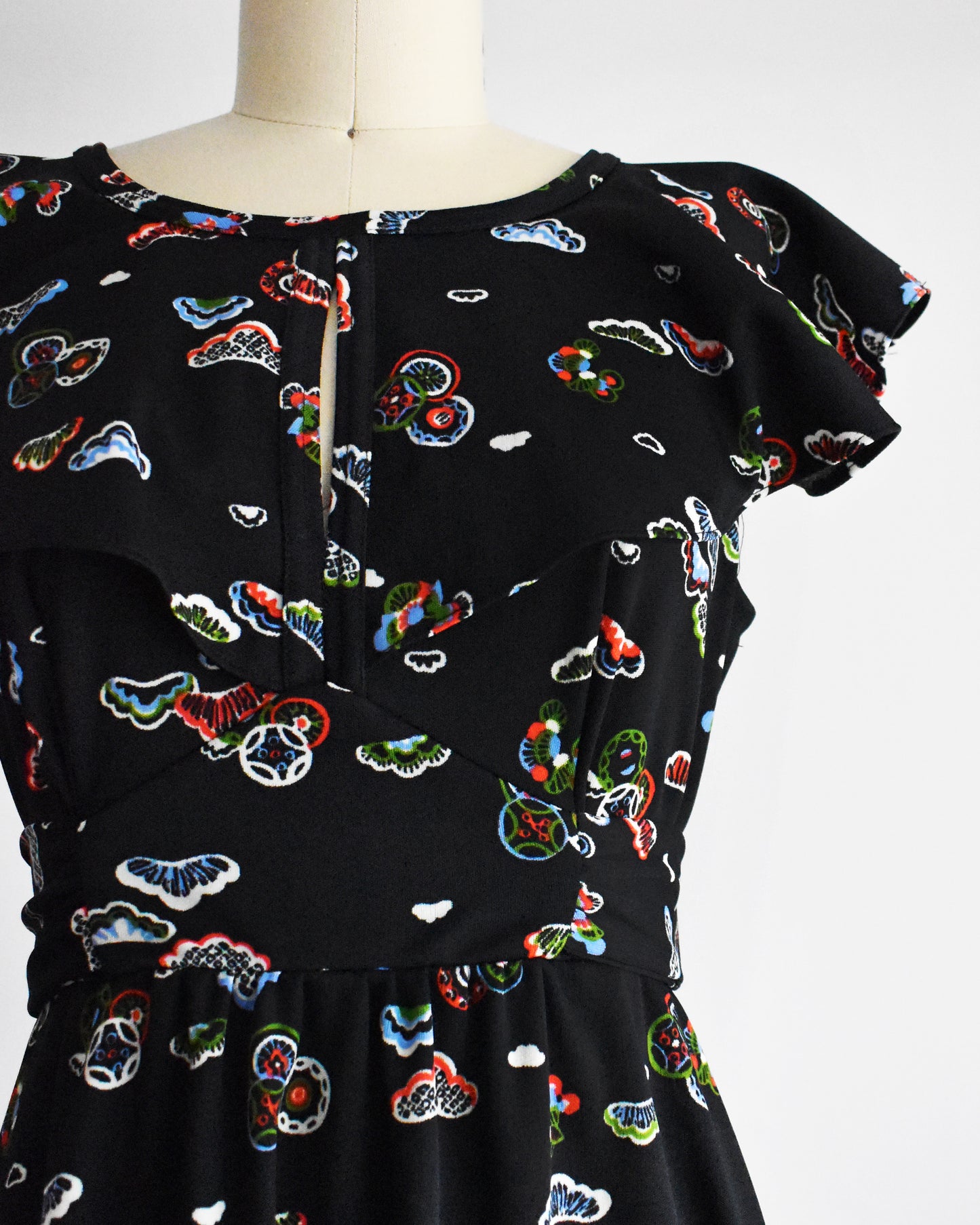 Close up of the abstract print and flutter sleeves on the bodice of the dress