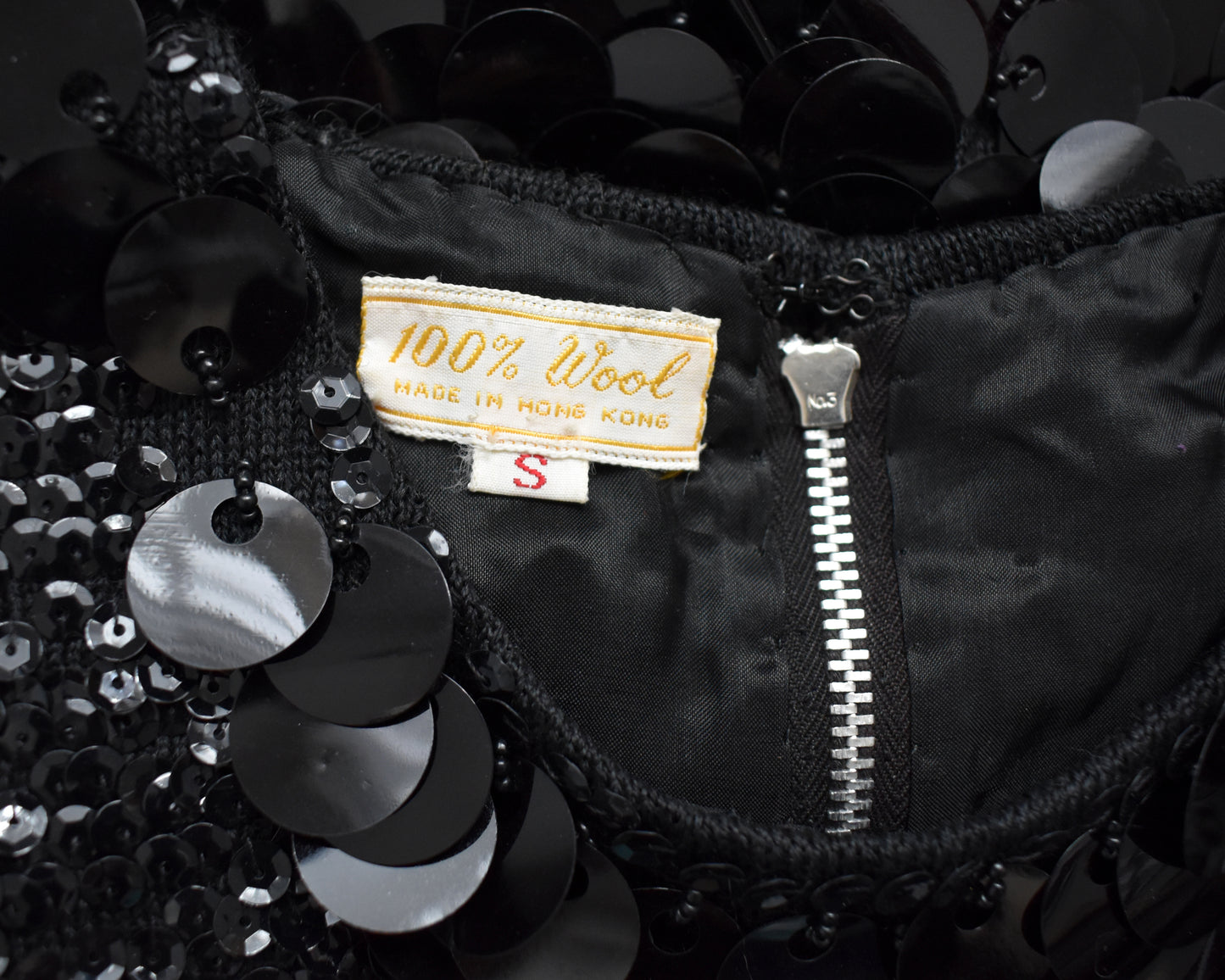 close up of the tag which says 100% Wool Made in Hong Kong