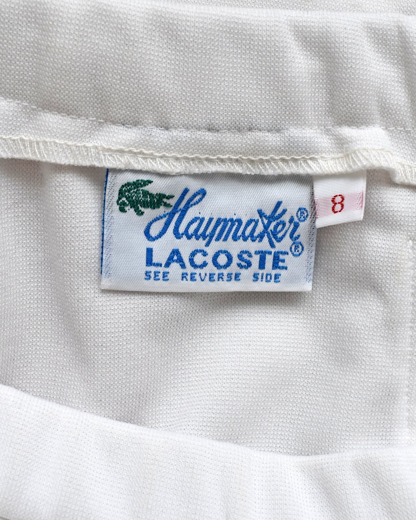 Close-up of a Haymaker Lacoste label with a crocodile logo.