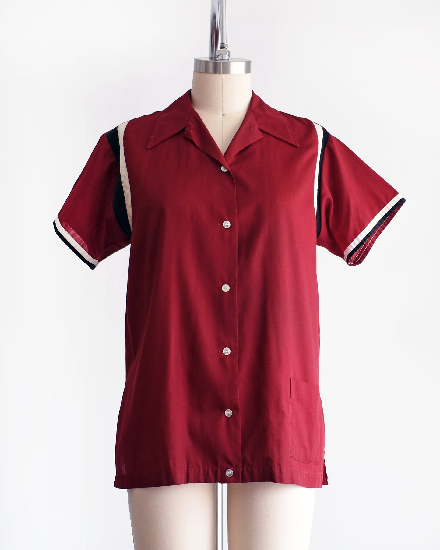 front view of a vintage 1960s Hilton bowling shirt on a mannequin against a white background