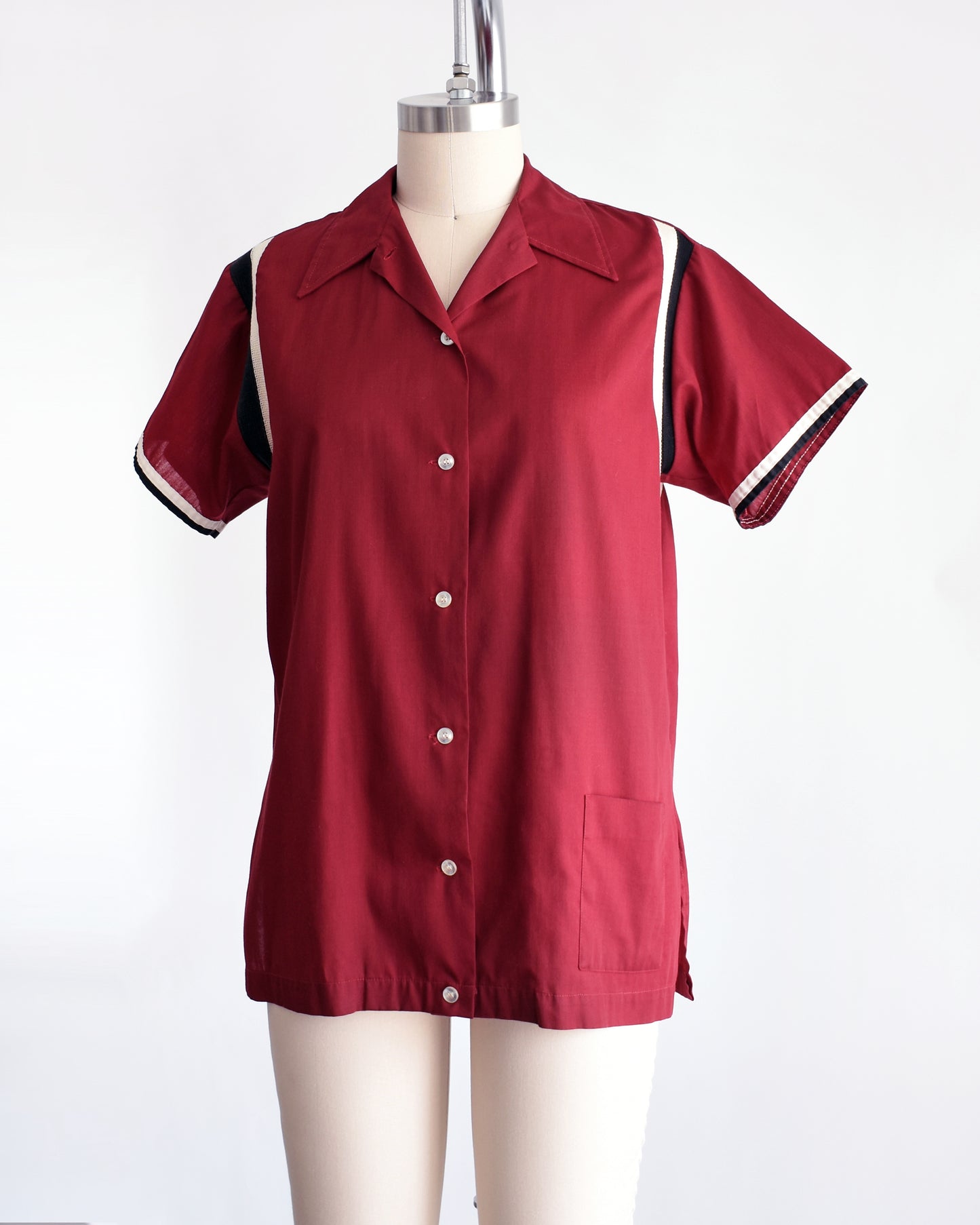 side front view of a vintage 1960s Hilton bowling shirt with white text on a mannequin against a white background