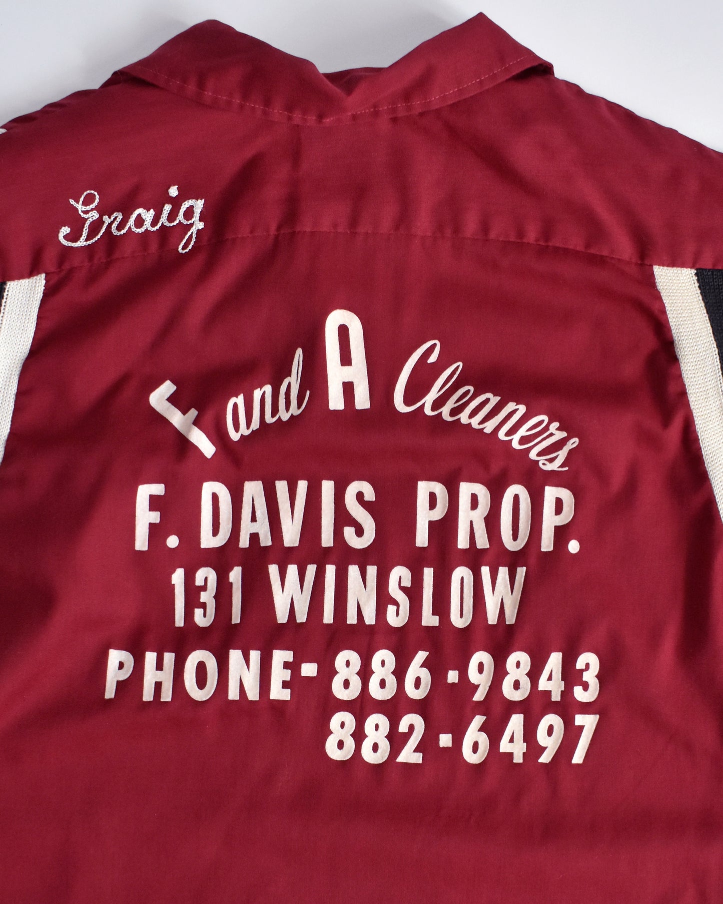 overlay view of the back of a vintage 1950s Hilton bowling shirt with white text on a mannequin against a white background