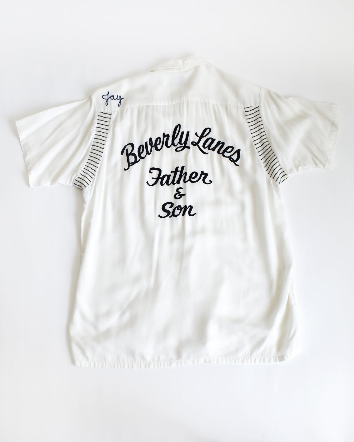 a vintage 1950s Olympian bowling white shirt with 'Beverly Lanes Father & Son' text on a white background