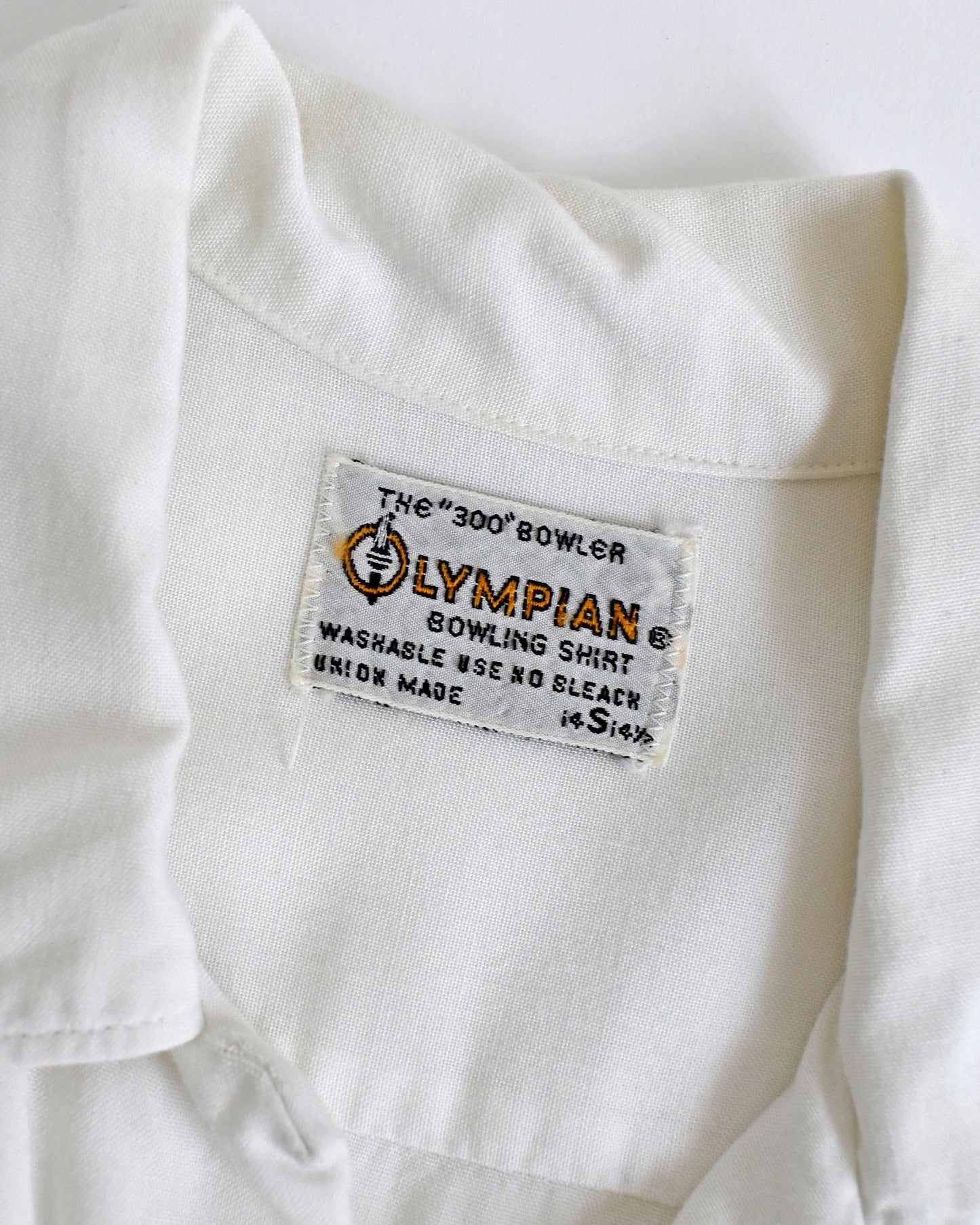 close up of the Olympian bowling shirt tag