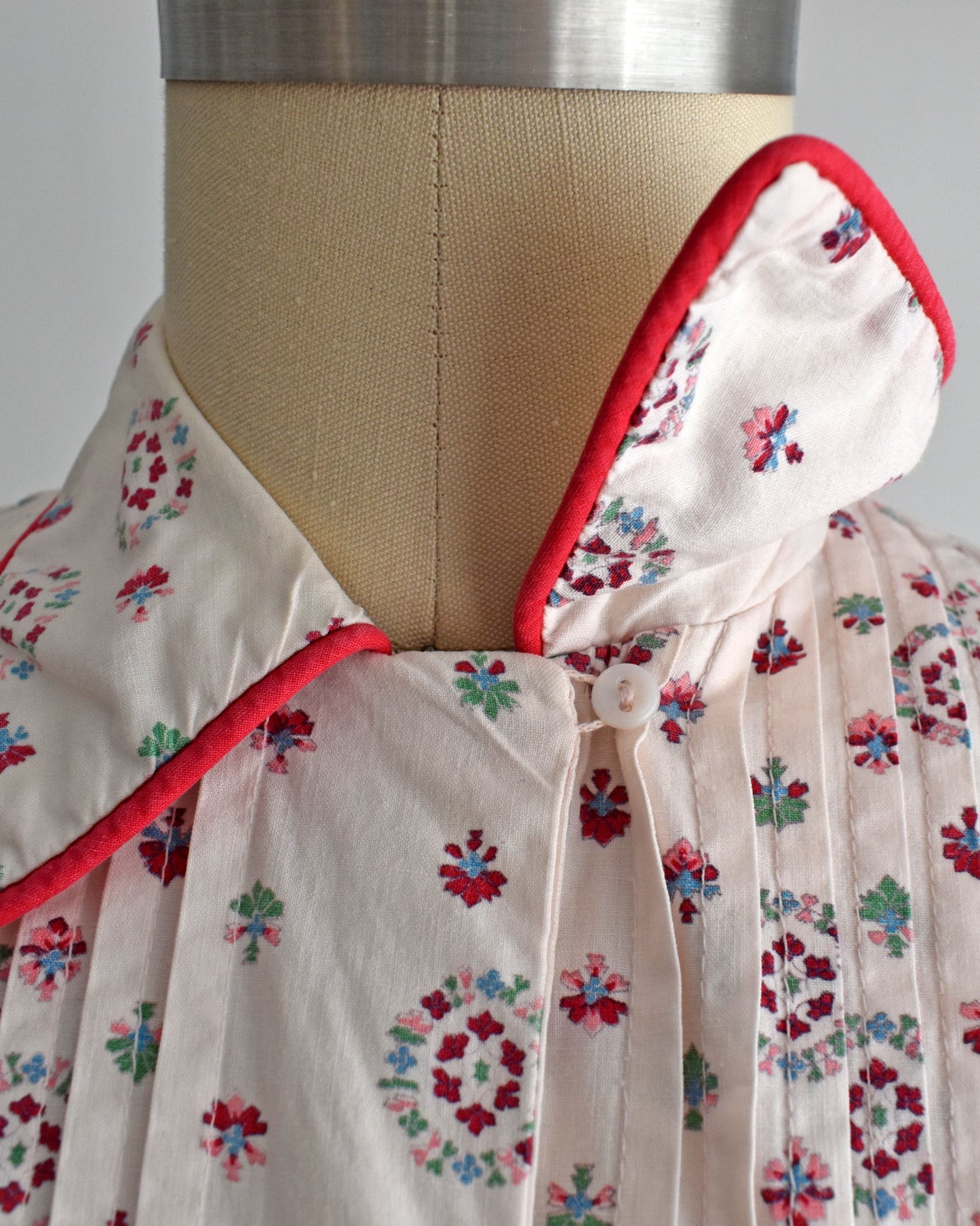 close up of the collar with one of them flipped showing the button underneath