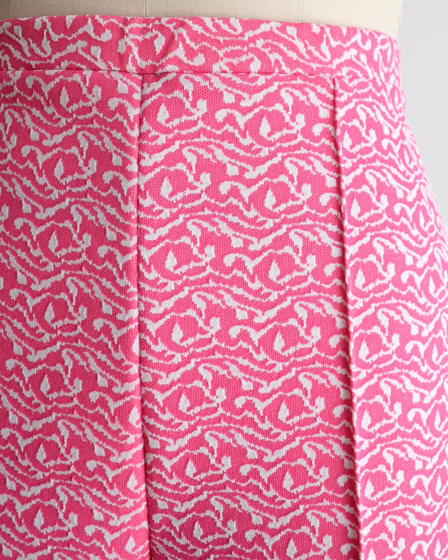 close up of vintage 70s pink and white shorts on a mannequin against a white background