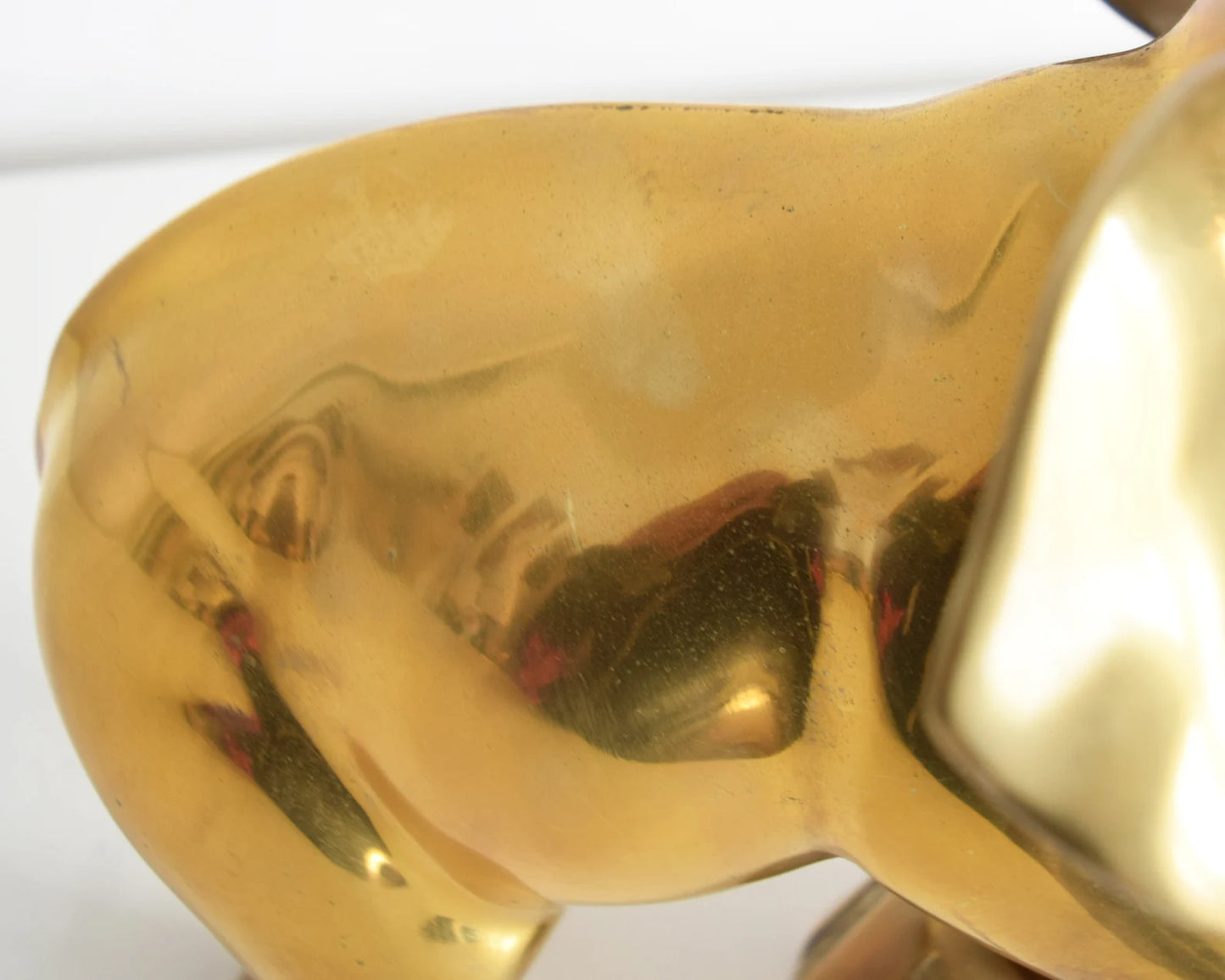 Close up of the back side of the elephant which has some light spots on the brass