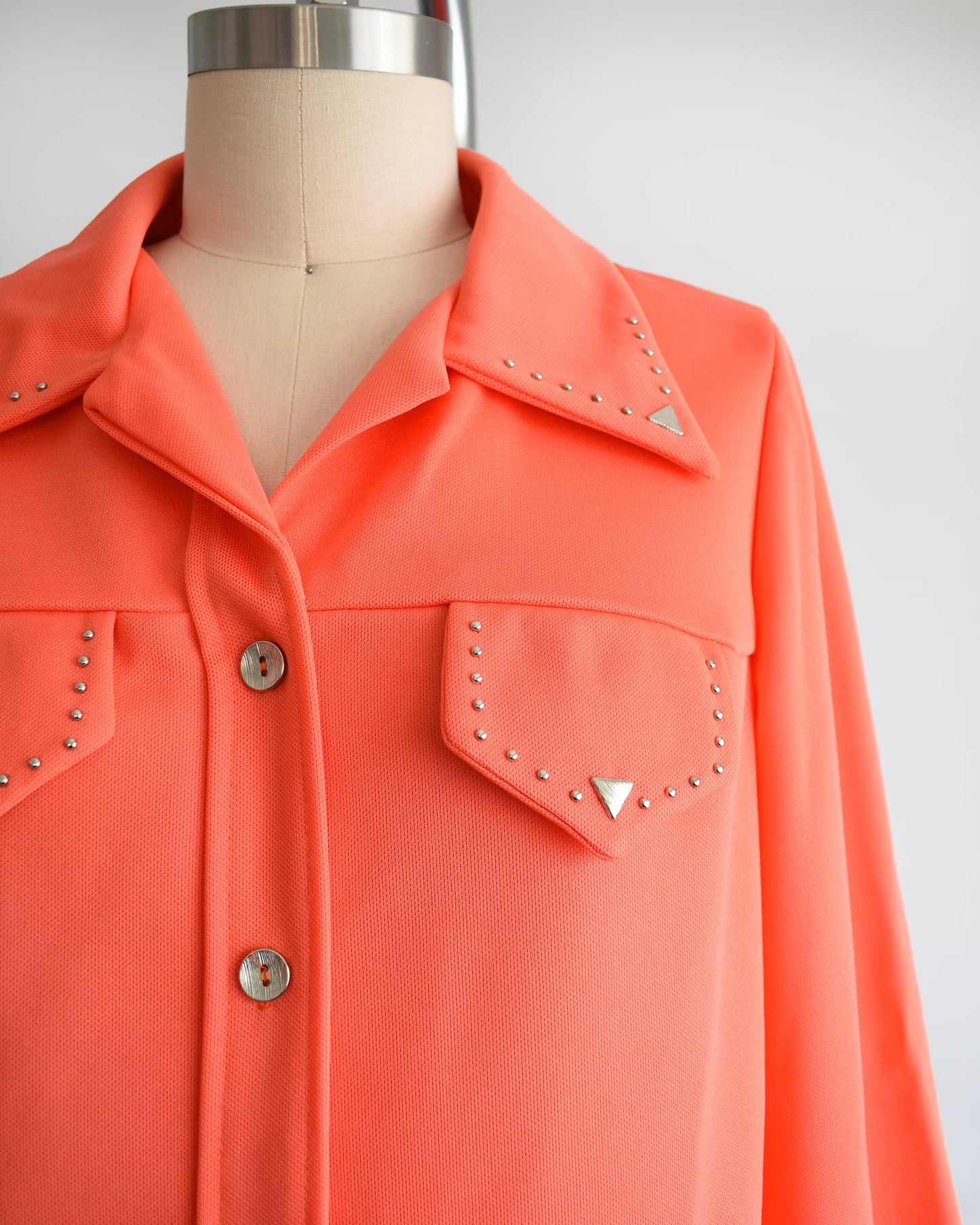 close up of top with silver studs