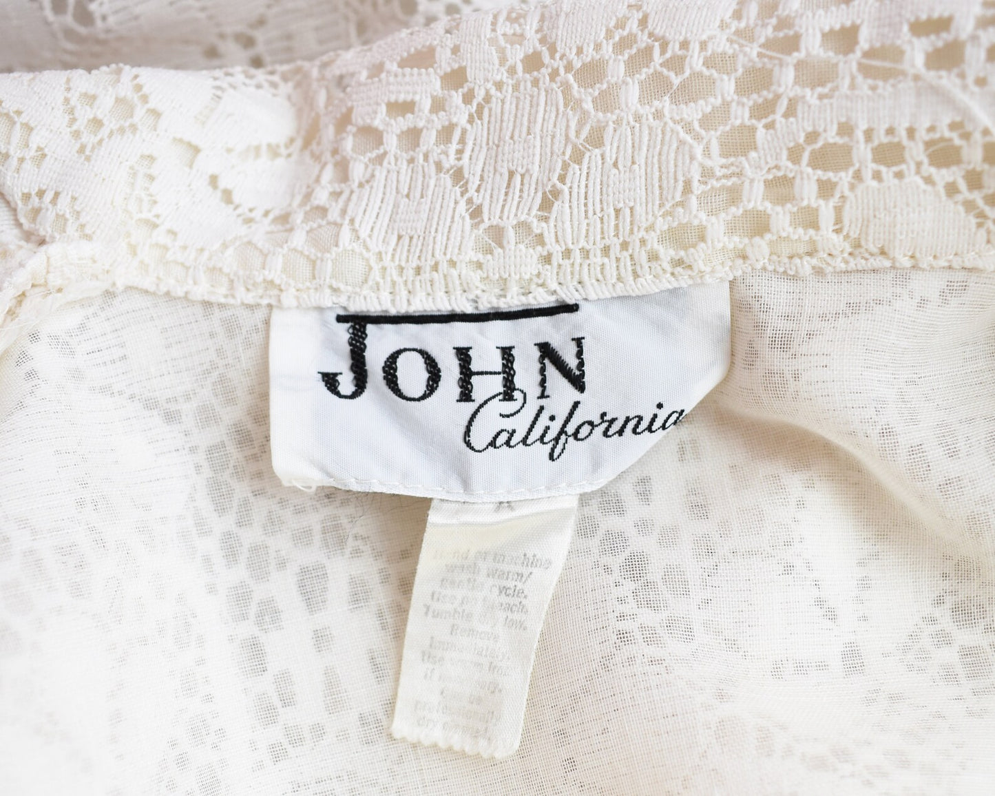 Close up of tag that says John California along with a laundry care tag