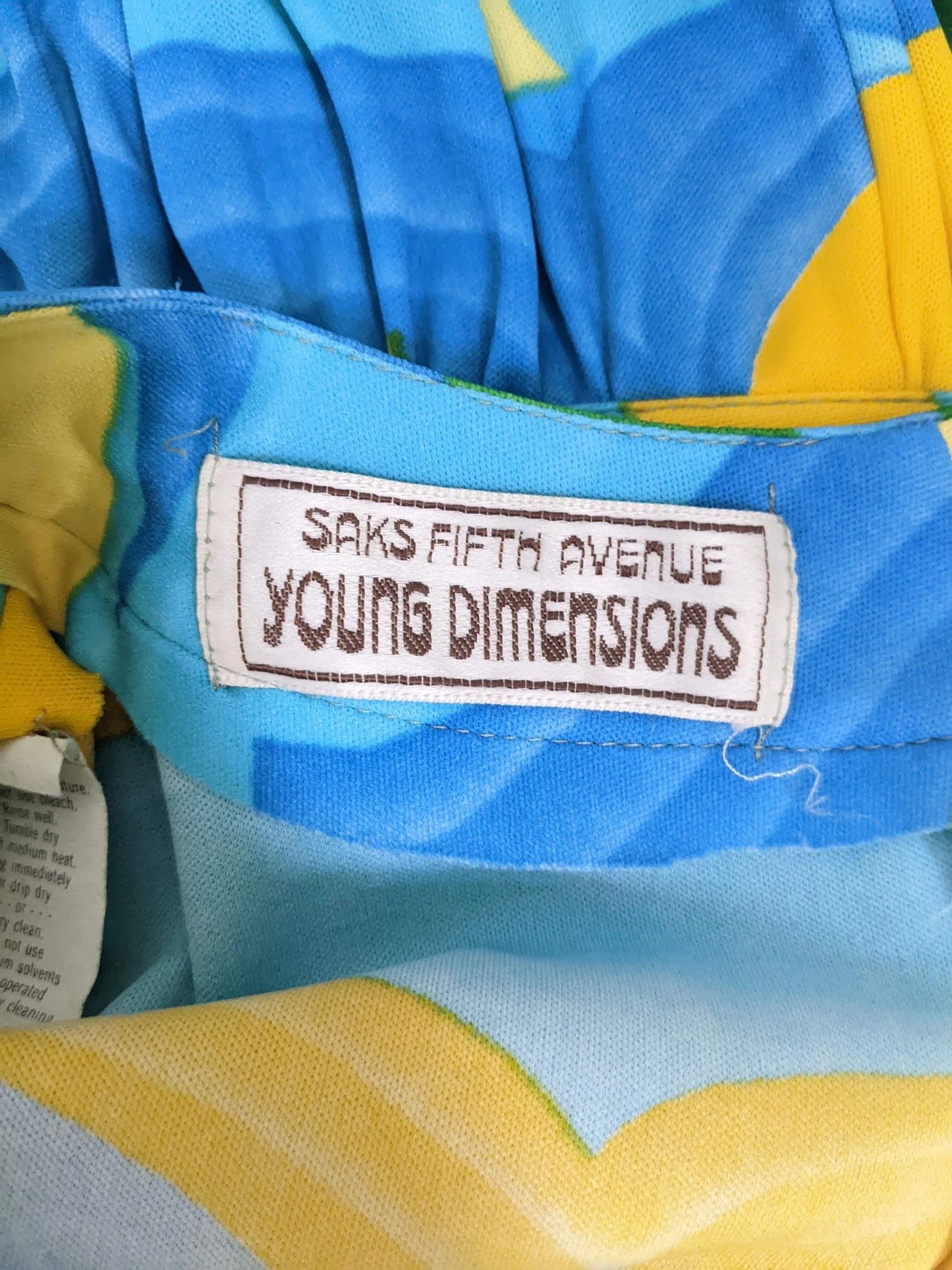 Close up of the tag that says Saks Fifth Avenue Young Dimensions