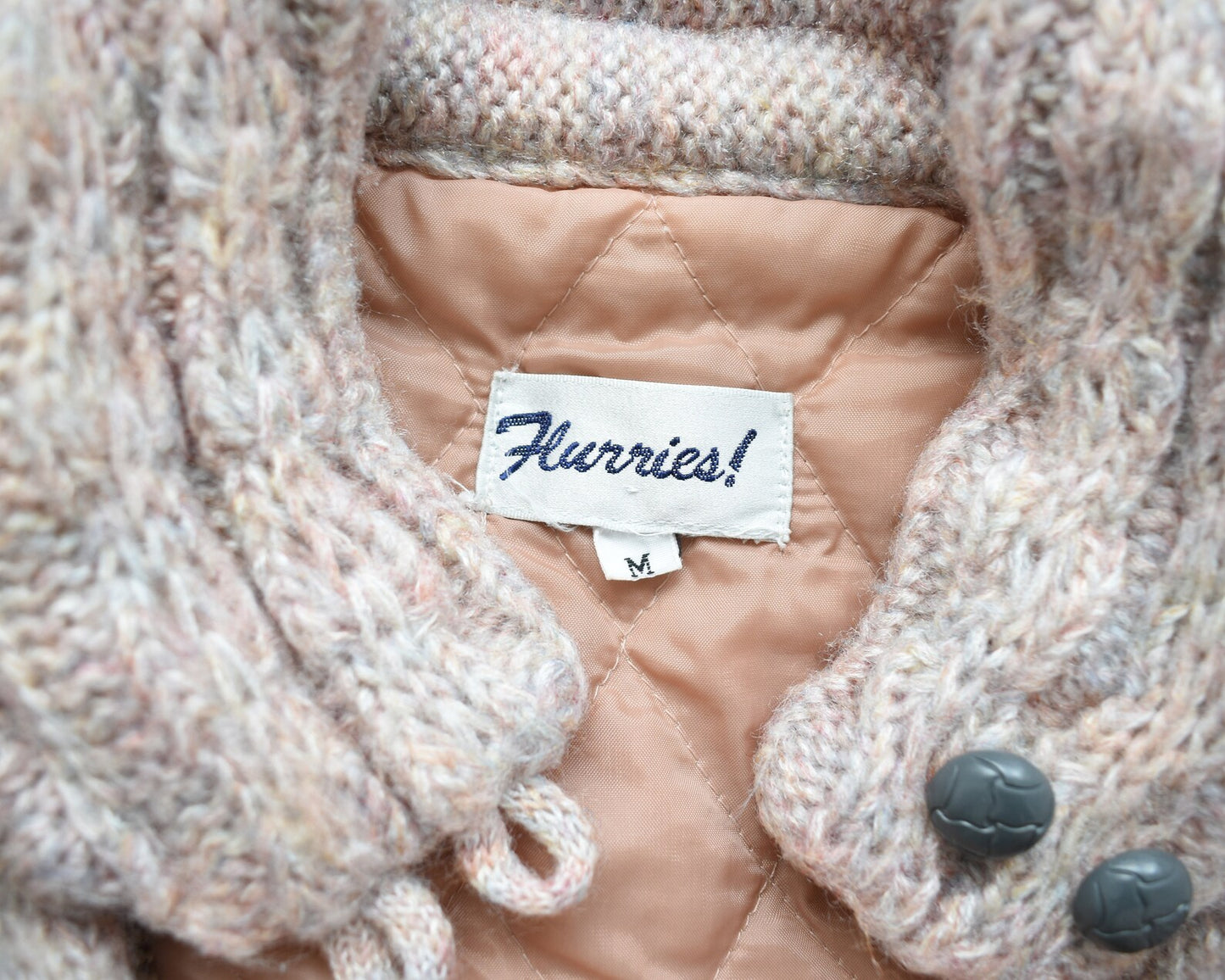 Close up of the waist, cable knit detail, and sleeve