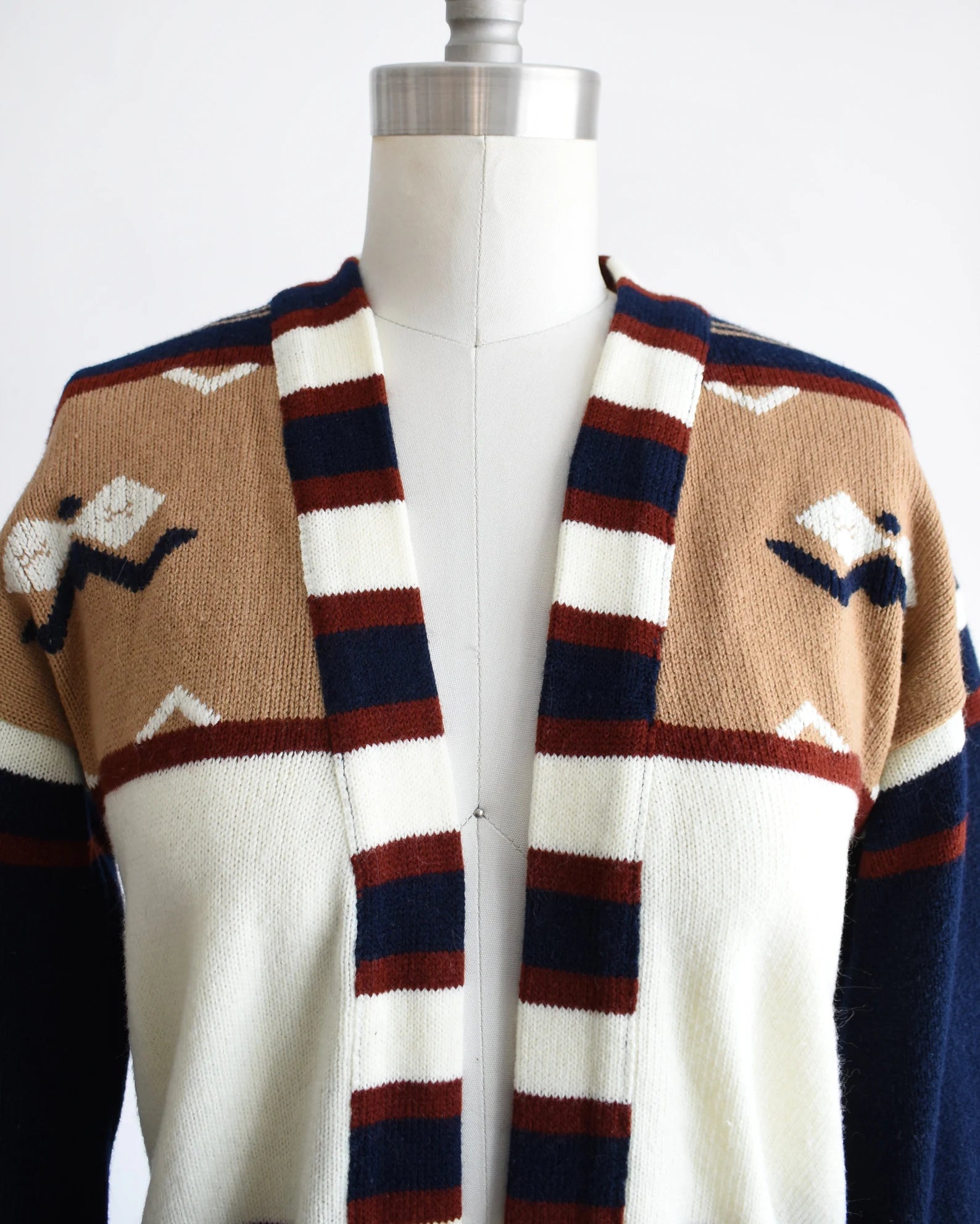 Close up of the upper part of the cardigan that shows the southwestern motif on the shoulders