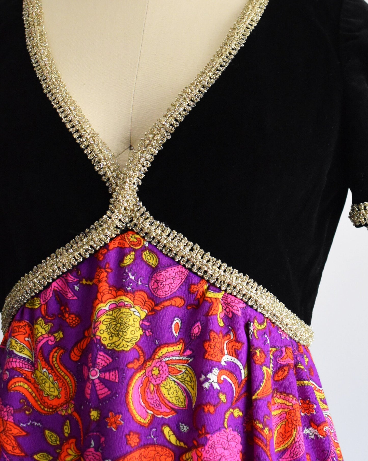 Close up of the bodice and empire waist area which shows the metallic gold ribbon trim