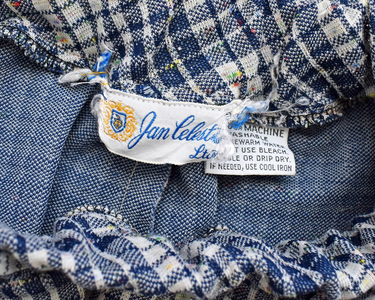 Close up of the tag that says Jan Celeste along with a care tag