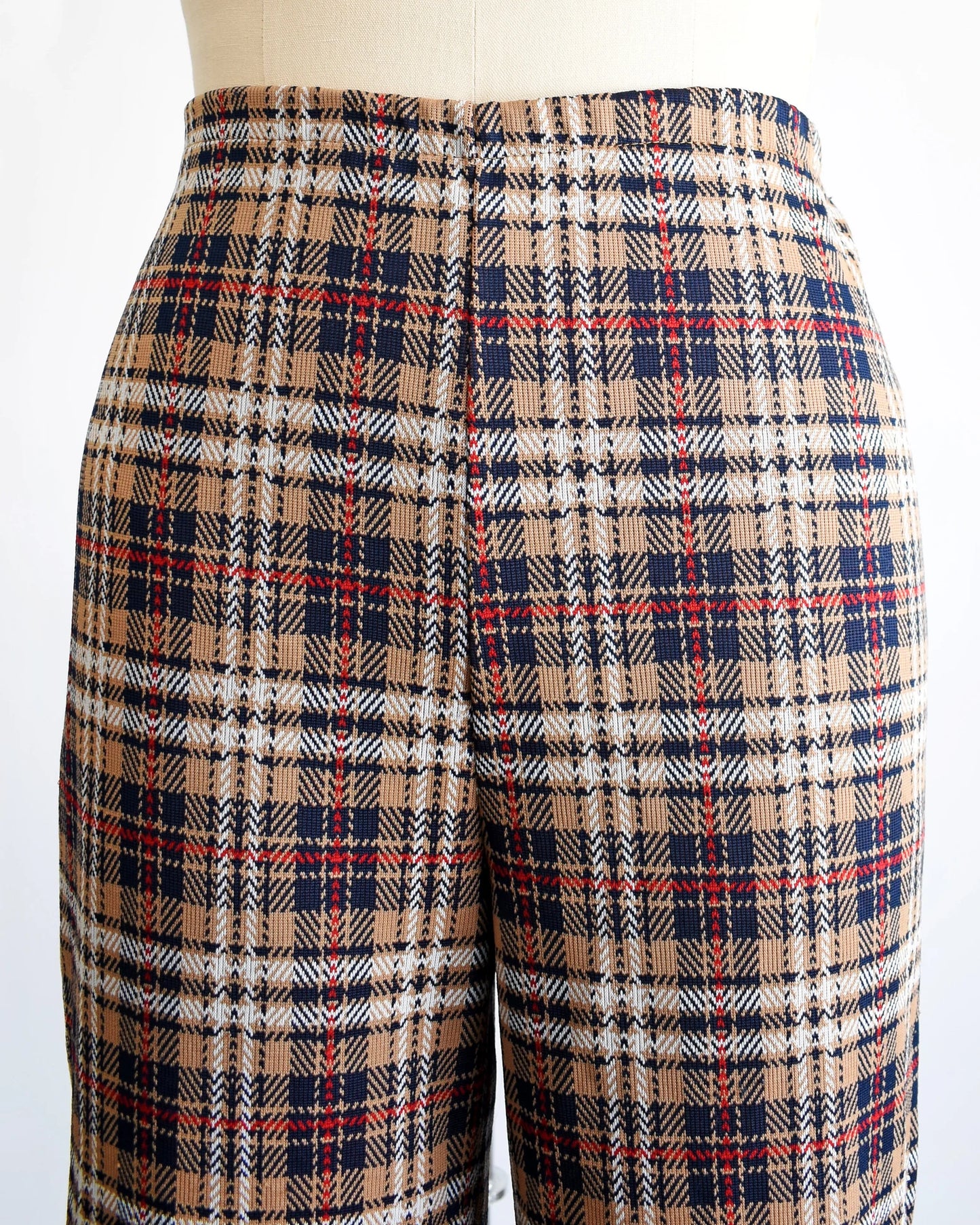 Close up of the waistline showing the brown, blue, red, black, and white plaid