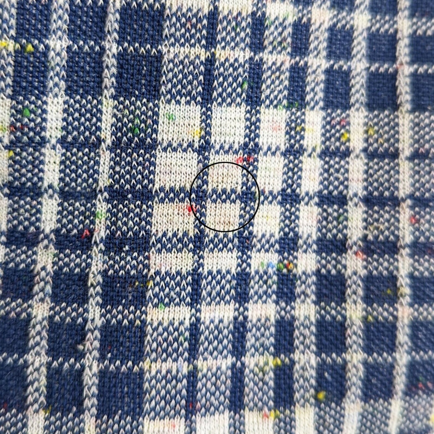 A close up of a small faint stain on the back of the right leg, towards the inside, that didn't come out during cleaning