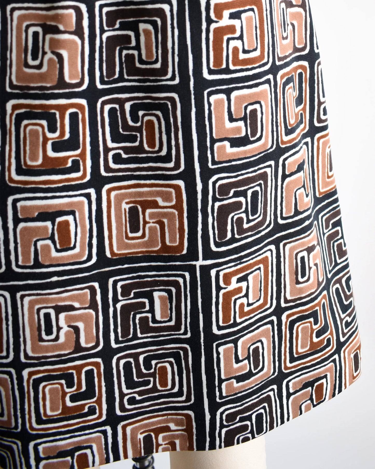 Close up of the brown, black, and white geometric print on the skirt.