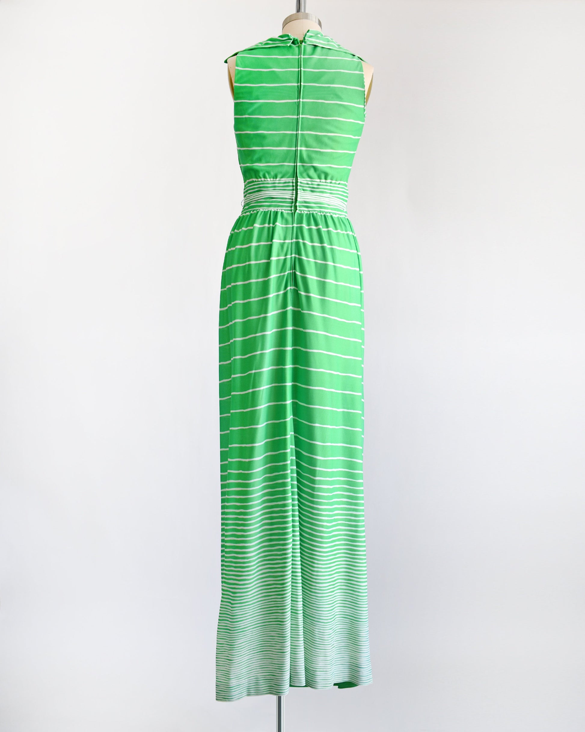 side view of a vintage green and white striped maxi dress on a dress form