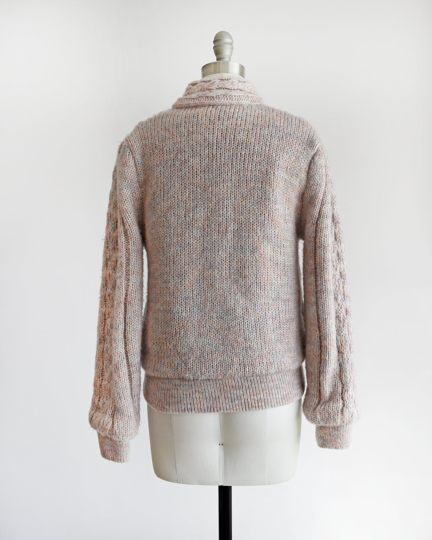 Back view of a A vintage 80s light purple sweater coat on a dress form.
