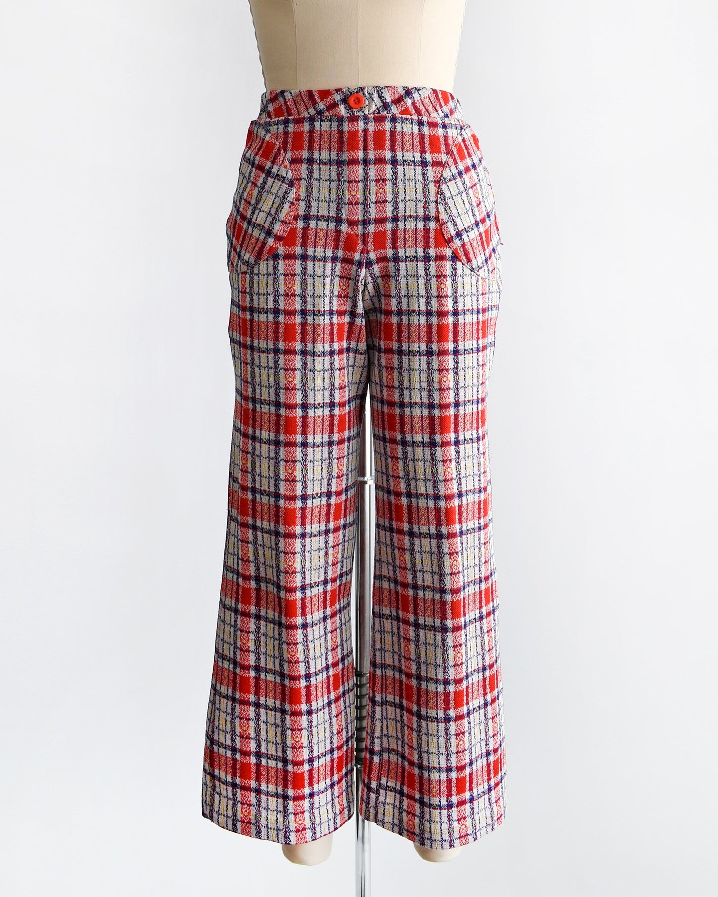 A vintage pair of 70s red white and blue plaid wide leg pants on a dress form.