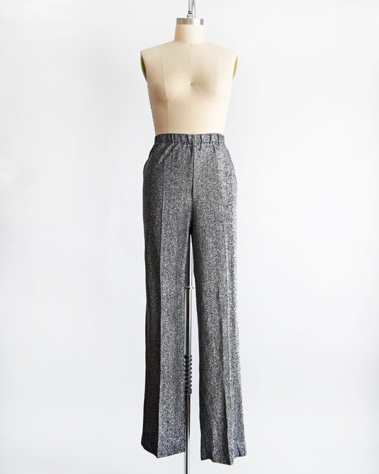 A vintage pair of 70s silver and black metallic pants on a dress form.