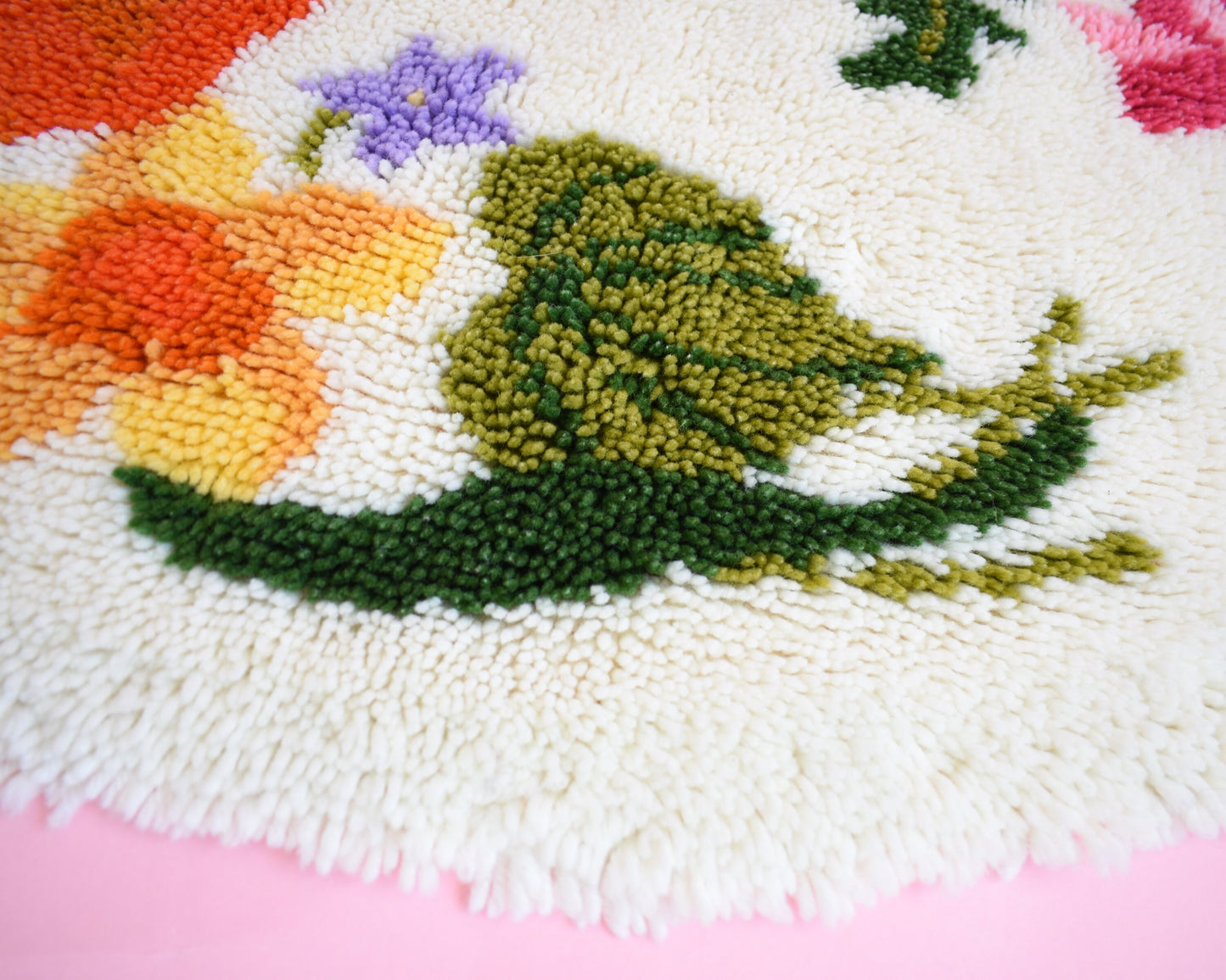 Close up view of the shaggy yarn and floral motif