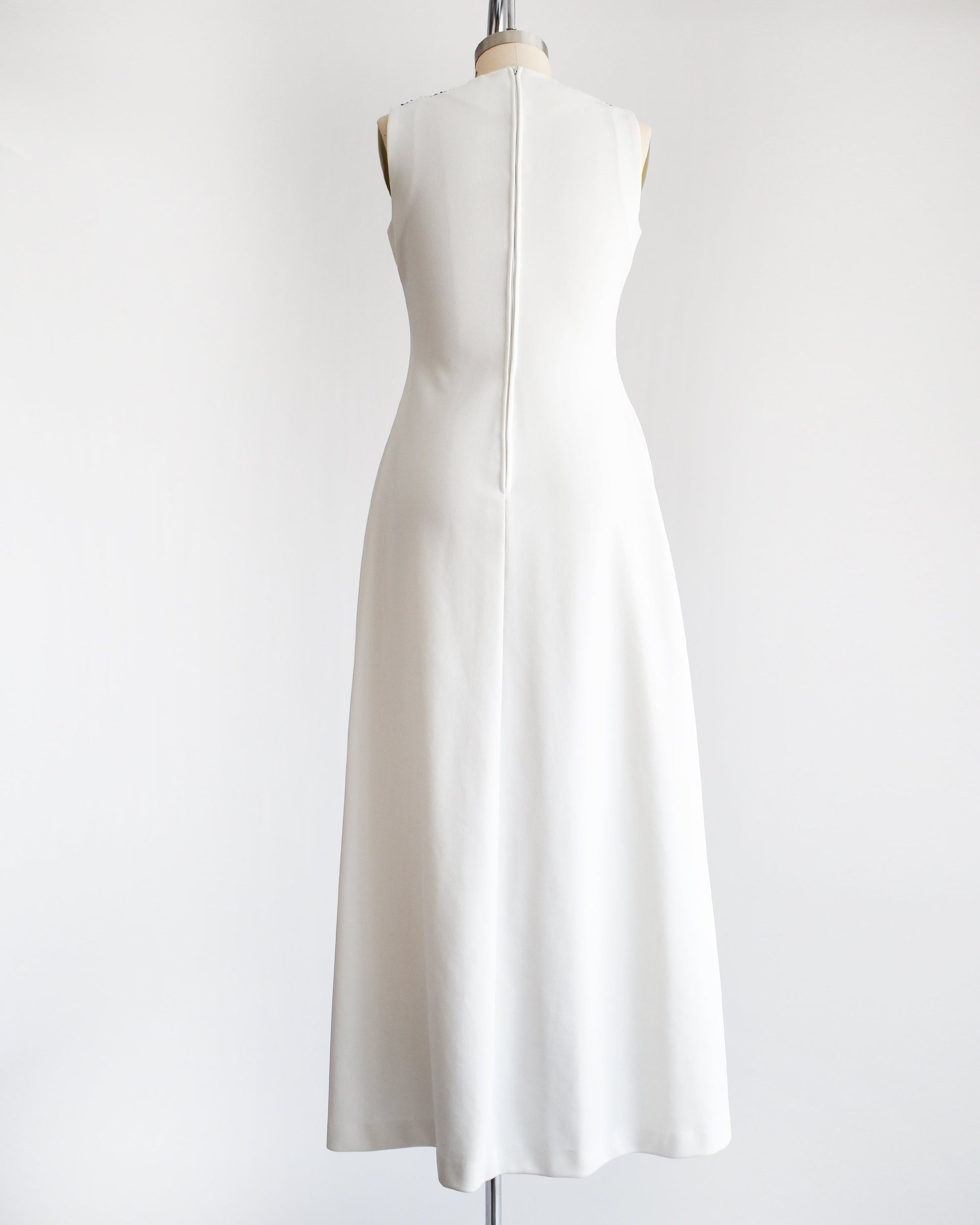 Back view of the dress which is a solid white and has a zipper up the back