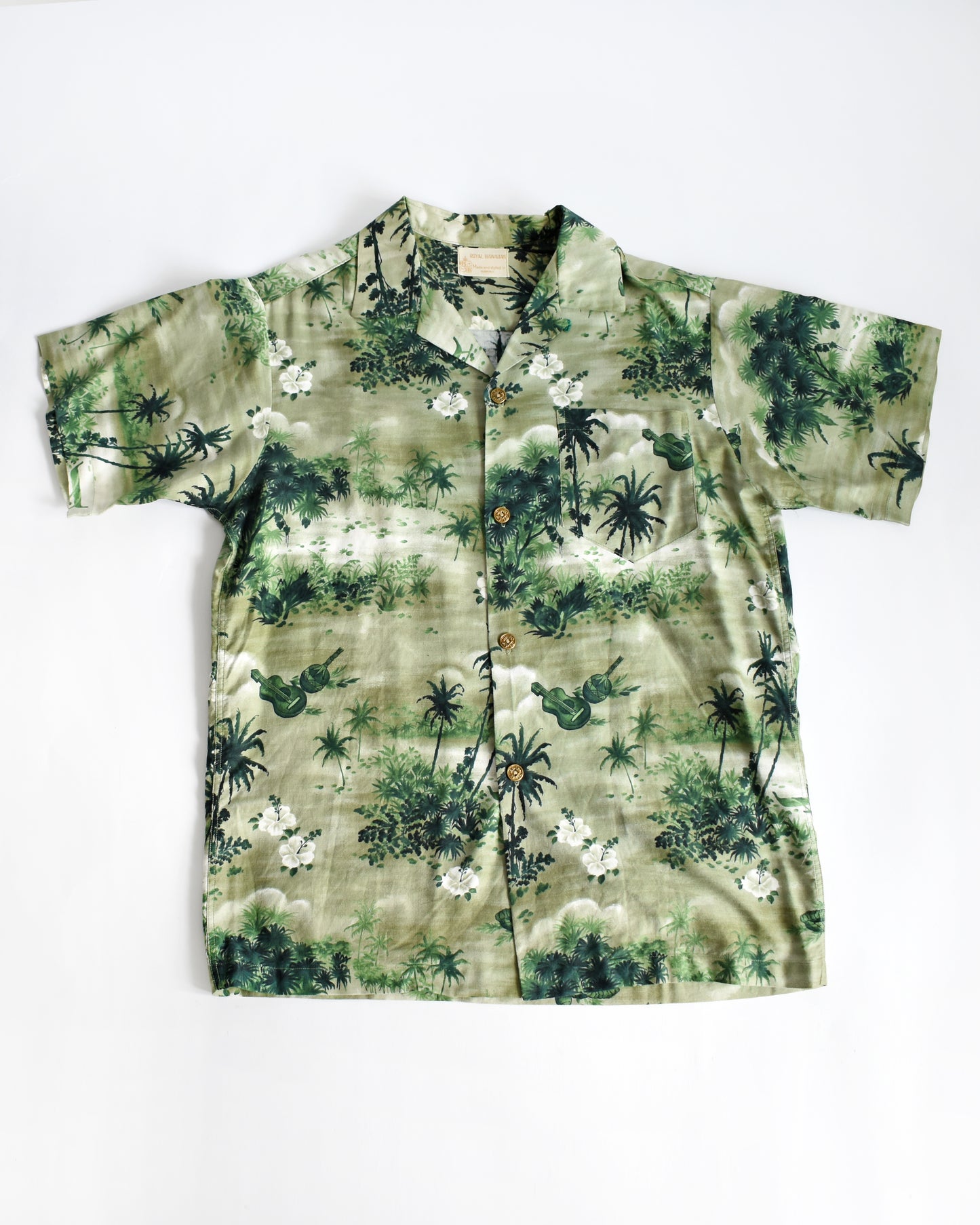 a vintage 1950s green Hawaiian shirt by Royal Hawaiian on a white background