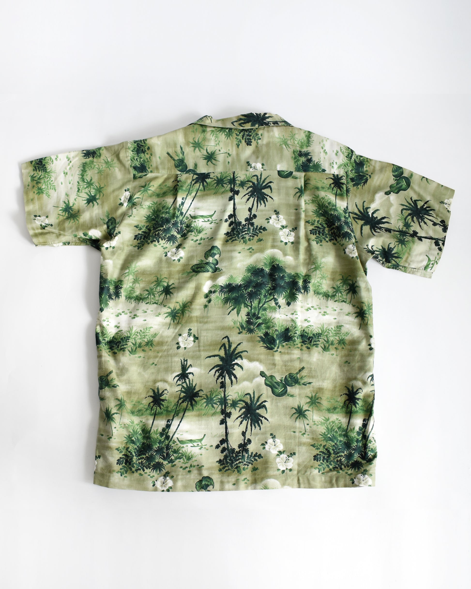 back view of a vintage 1950s green Hawaiian shirt by Royal Hawaiian on a white background