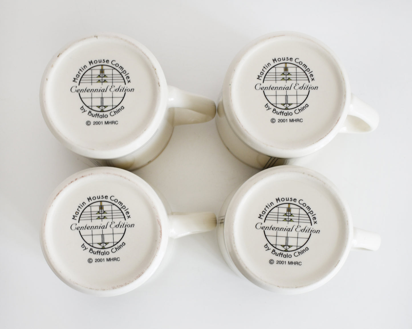 overhead shot of the base of the mugs that says Martin House Complex, Centennial Edition, by Buffalo China, 2001