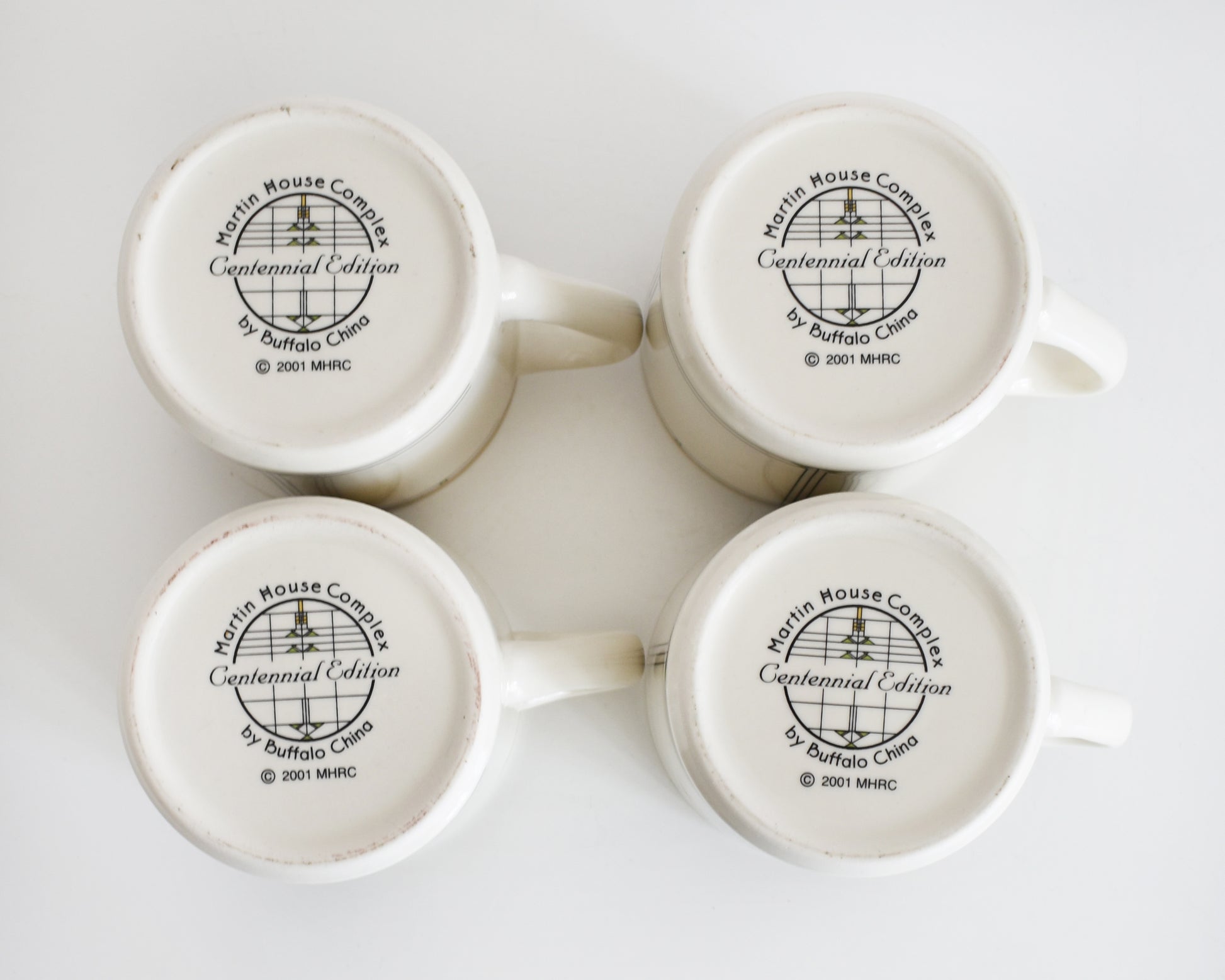 overhead shot of the base of the mugs that says Martin House Complex, Centennial Edition, by Buffalo China, 2001