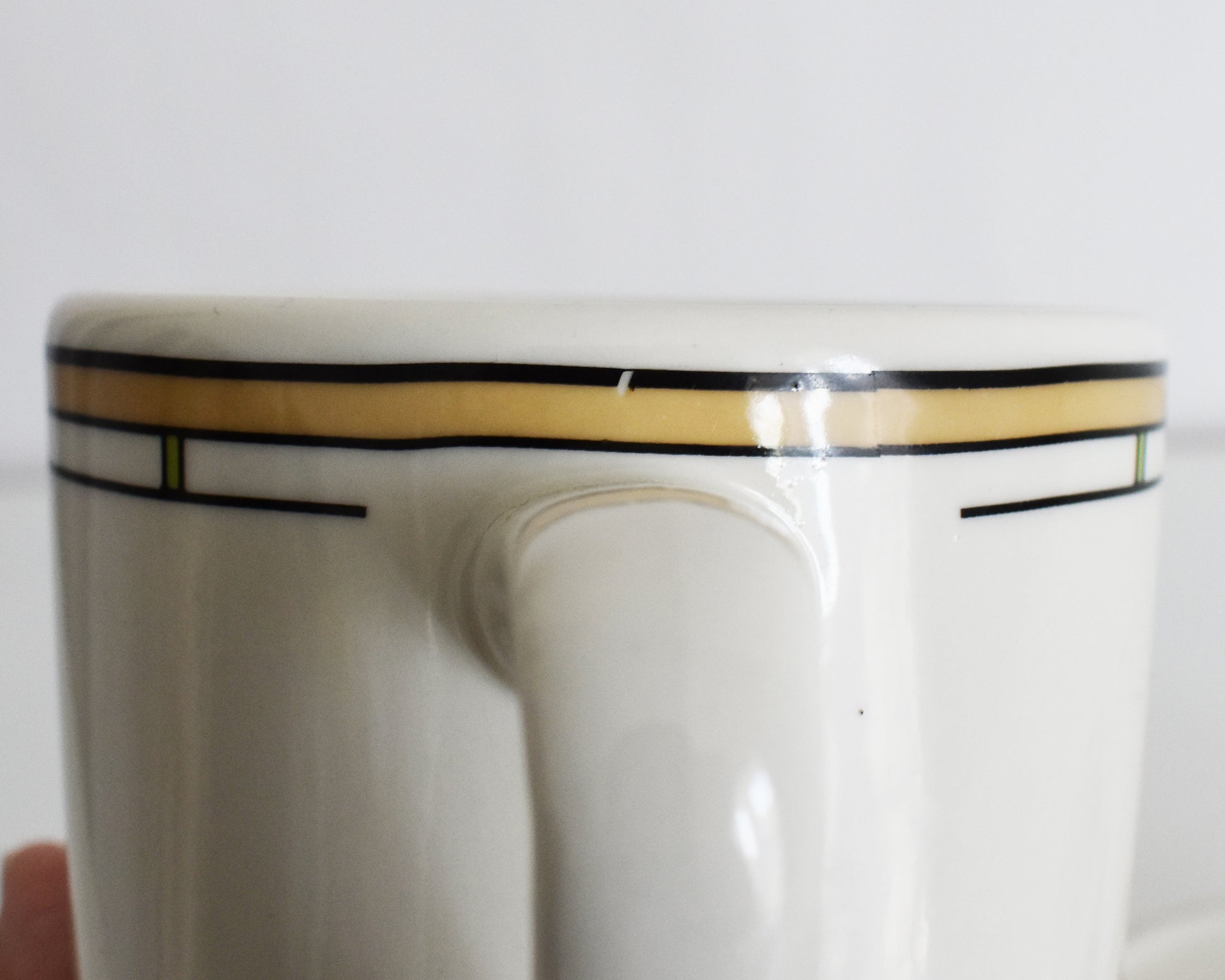 close up showing a small flaw on the trim of one of the mugs