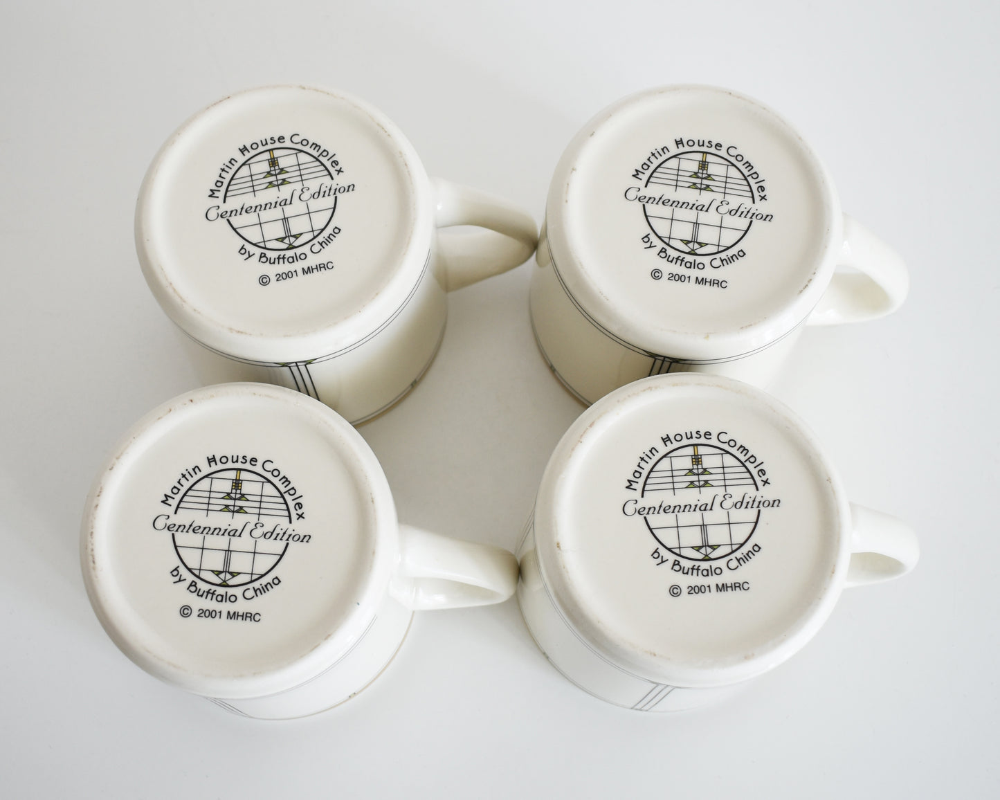 overhead shot of the base of the mugs that says Martin House Complex, Centennial Edition, by Buffalo China, 2001