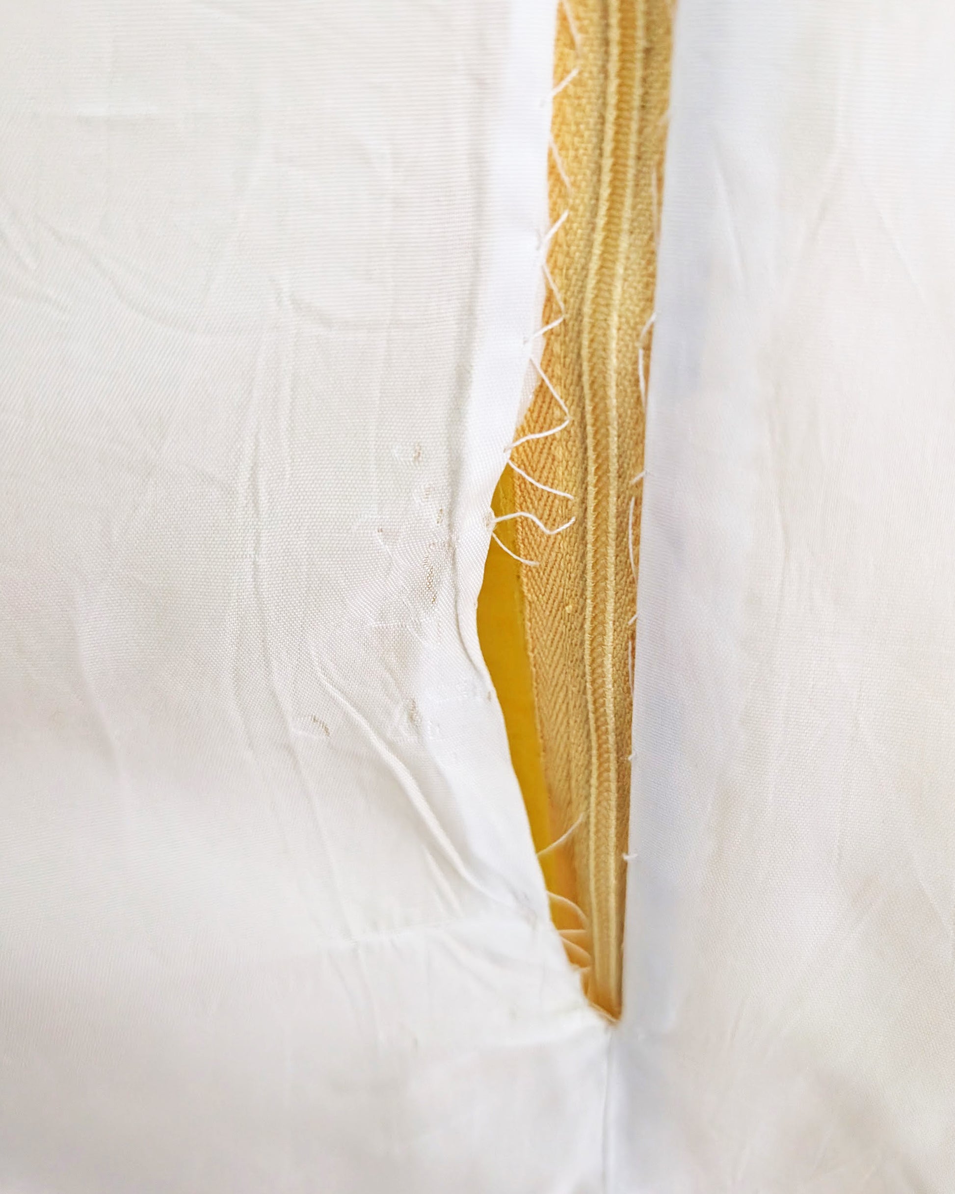 close up of the inside lining that has become detached from the zipper 