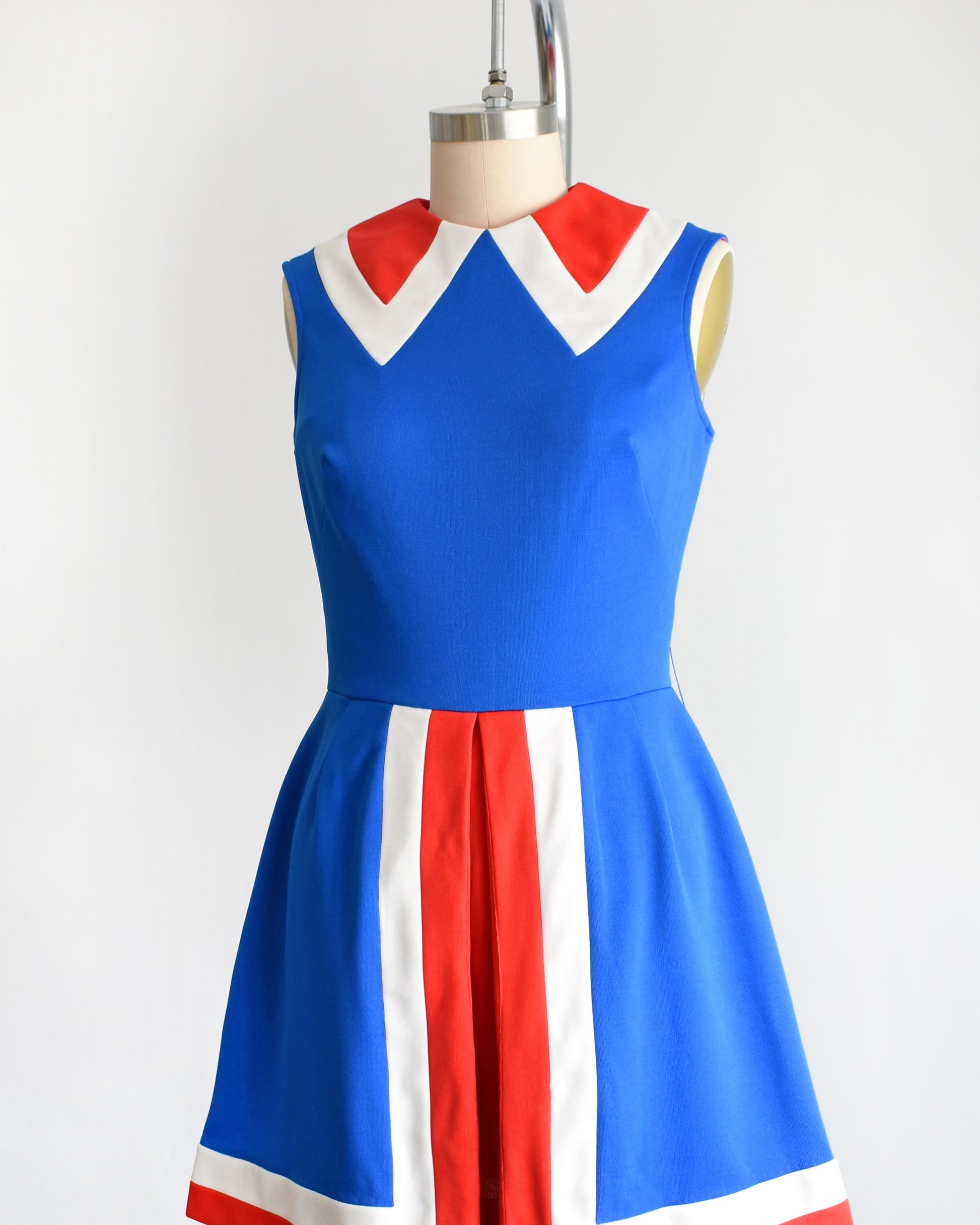 side front view of a vintage 60s/70s blue and red mod mini dress on a mannequin against a white background