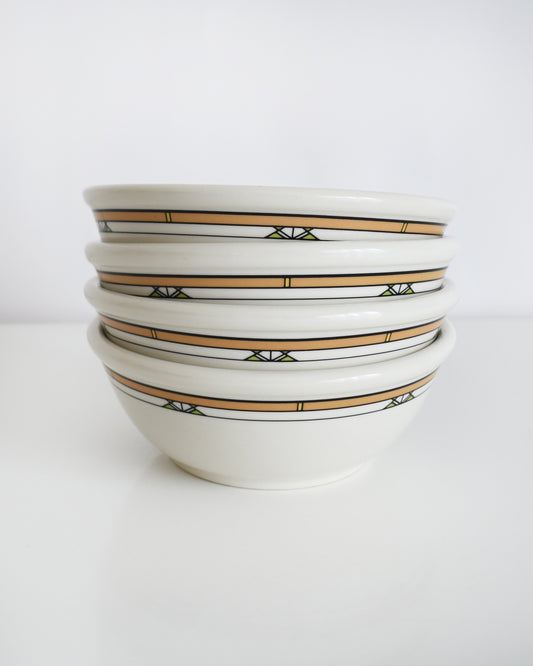 a stack of Frank Lloyd Wright Martin House white bowls with brown geometric patterns on a white background