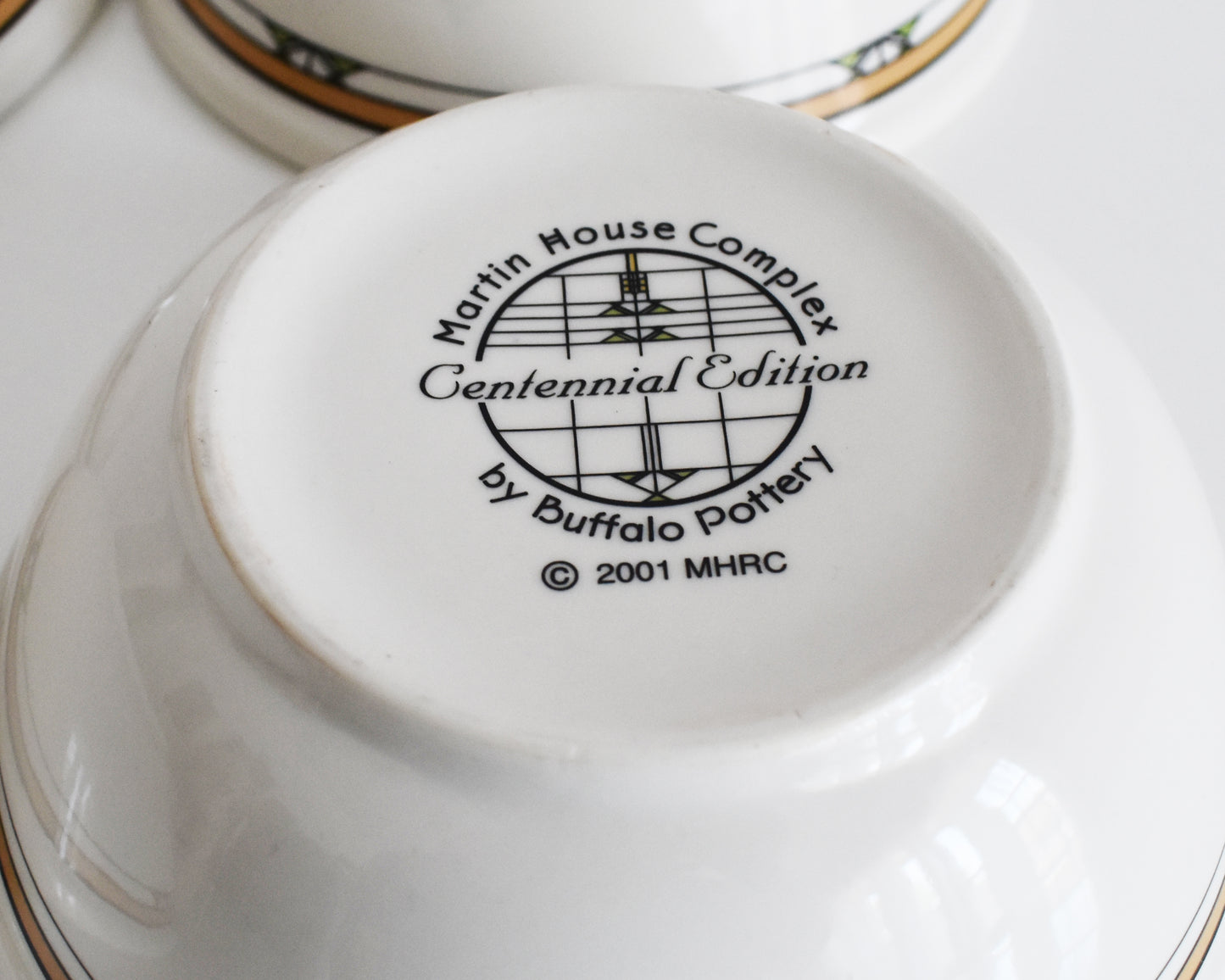 overhead shot of the base of the mugs that says Martin House Complex, Centennial Edition, by Buffalo China, 2001