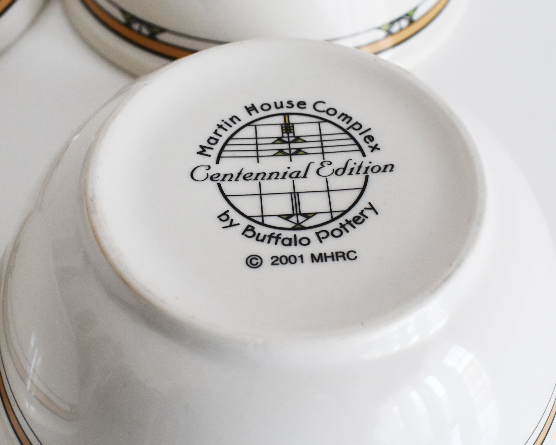 overhead shot of the base of the mugs that says Martin House Complex, Centennial Edition, by Buffalo China, 2001