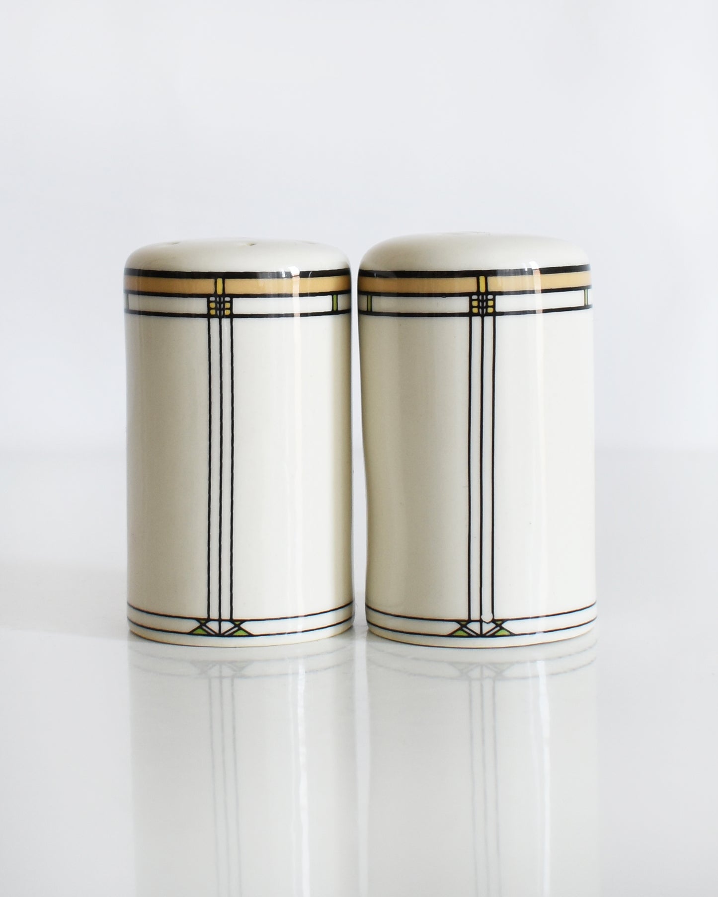 a set of ceramic Frank Lloyd Wright Martin House salt and pepper shakers on a white background