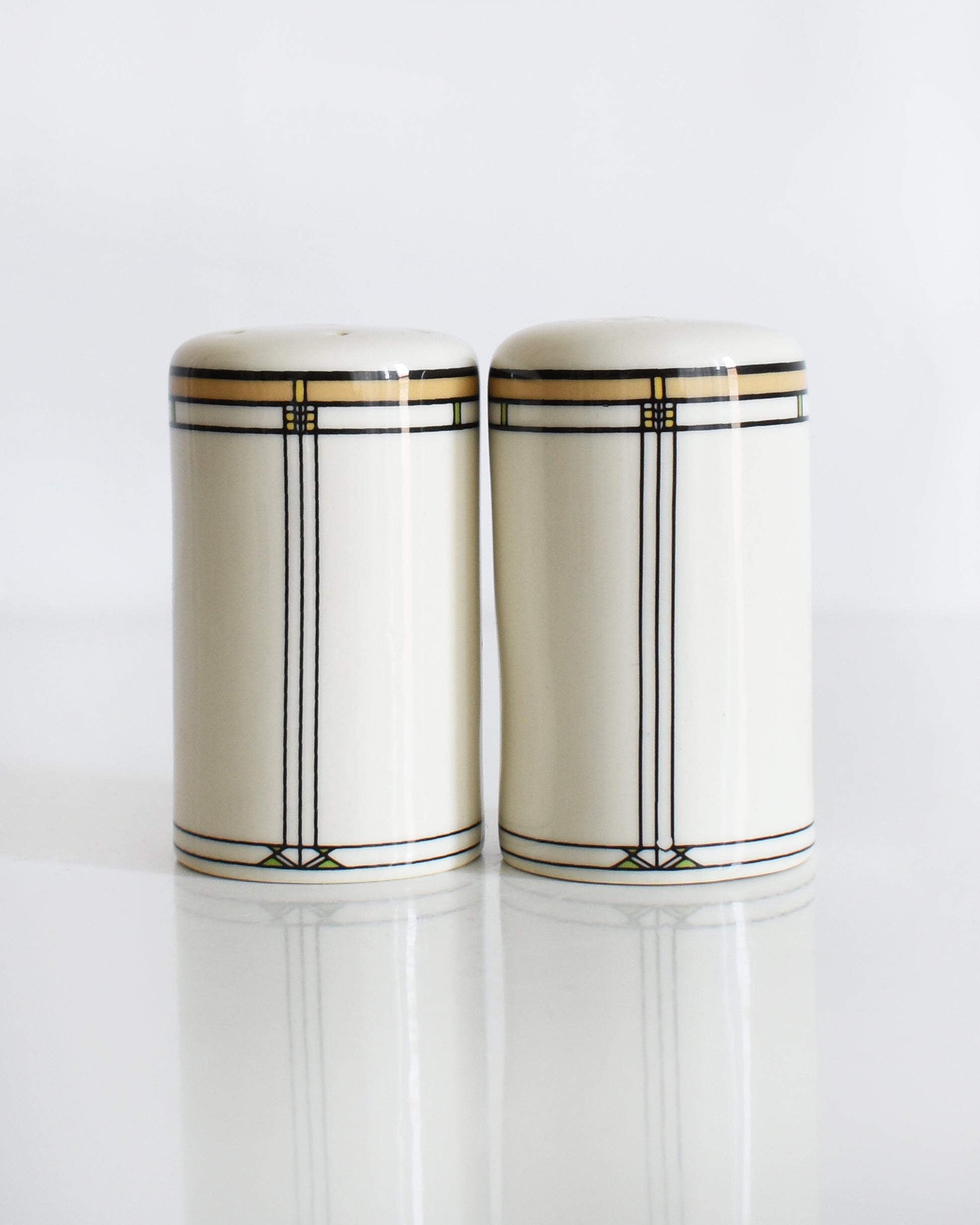 a set of ceramic Frank Lloyd Wright Martin House salt and pepper shakers on a white background