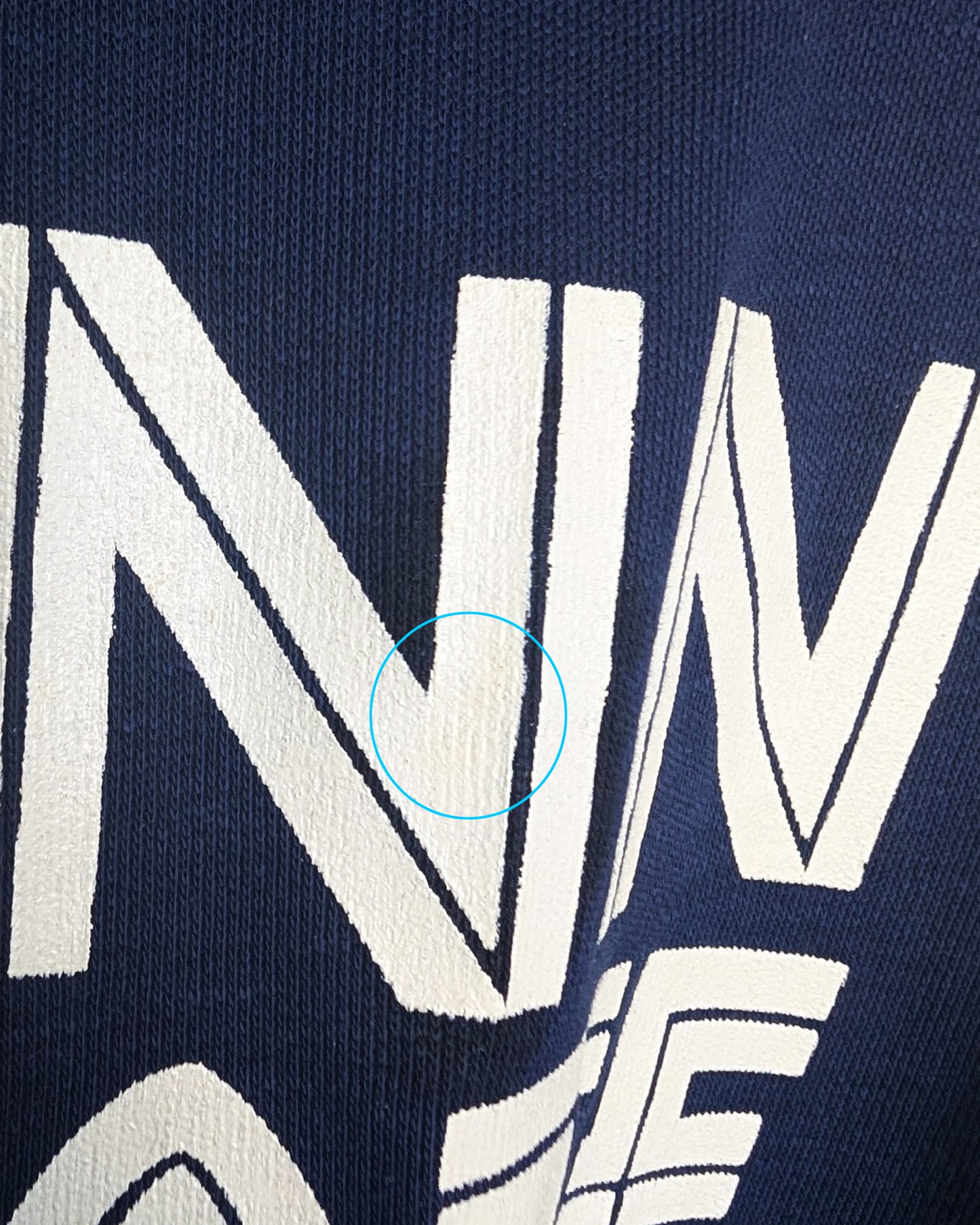 close up of the first N that has a faint yellow spot circled