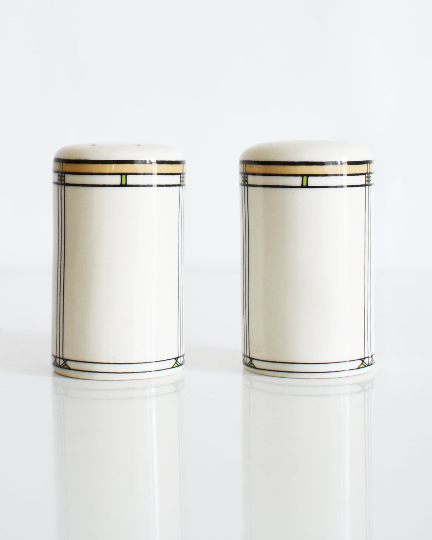 a set of ceramic Frank Lloyd Wright Martin House salt and pepper shakers on a white background