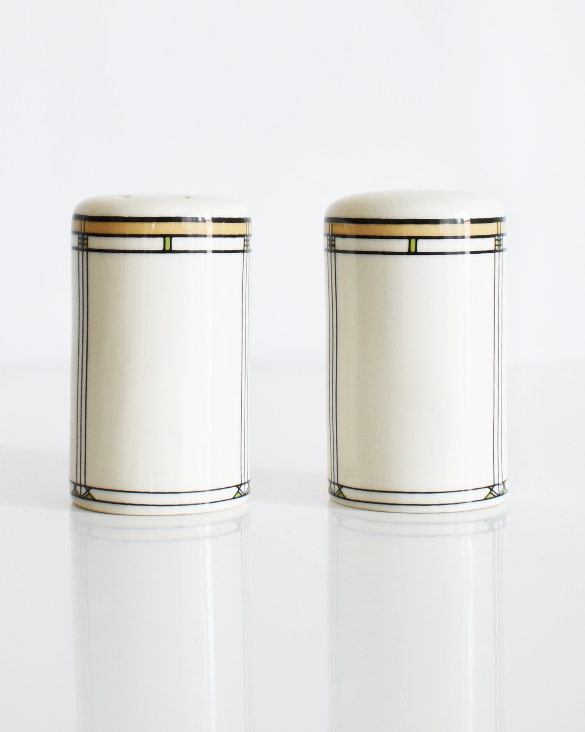 a set of ceramic Frank Lloyd Wright Martin House salt and pepper shakers on a white background