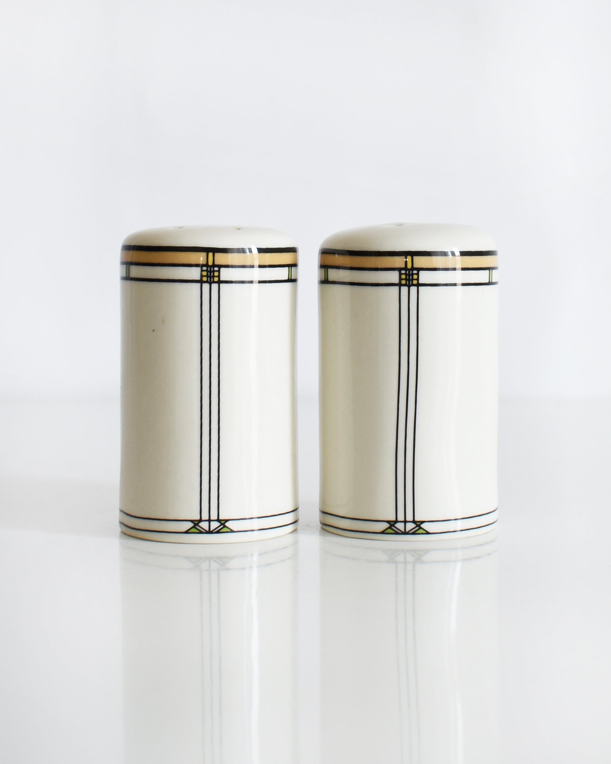 a set of ceramic Frank Lloyd Wright Martin House salt and pepper shakers on a white background