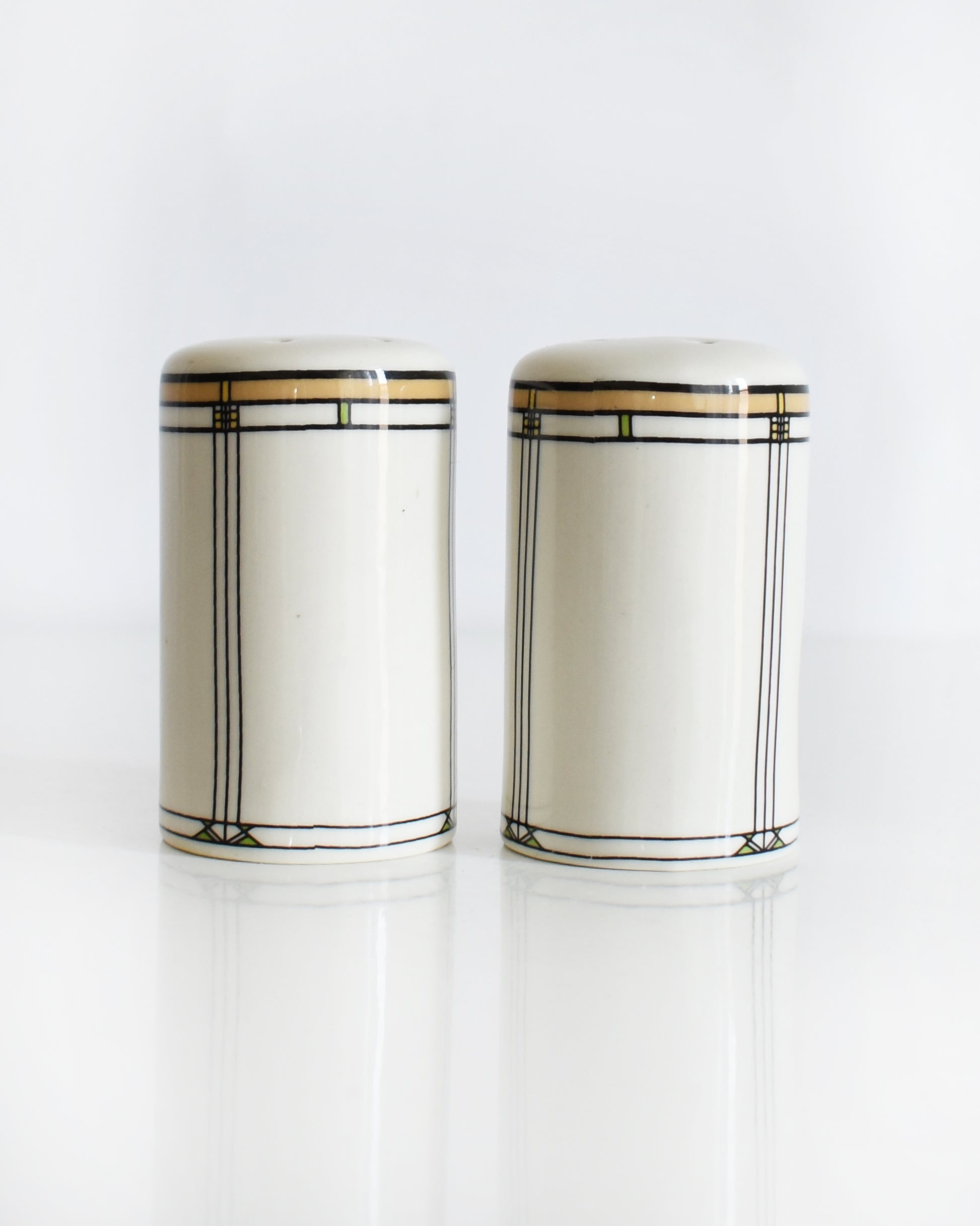 a set of ceramic Frank Lloyd Wright Martin House salt and pepper shakers on a white background