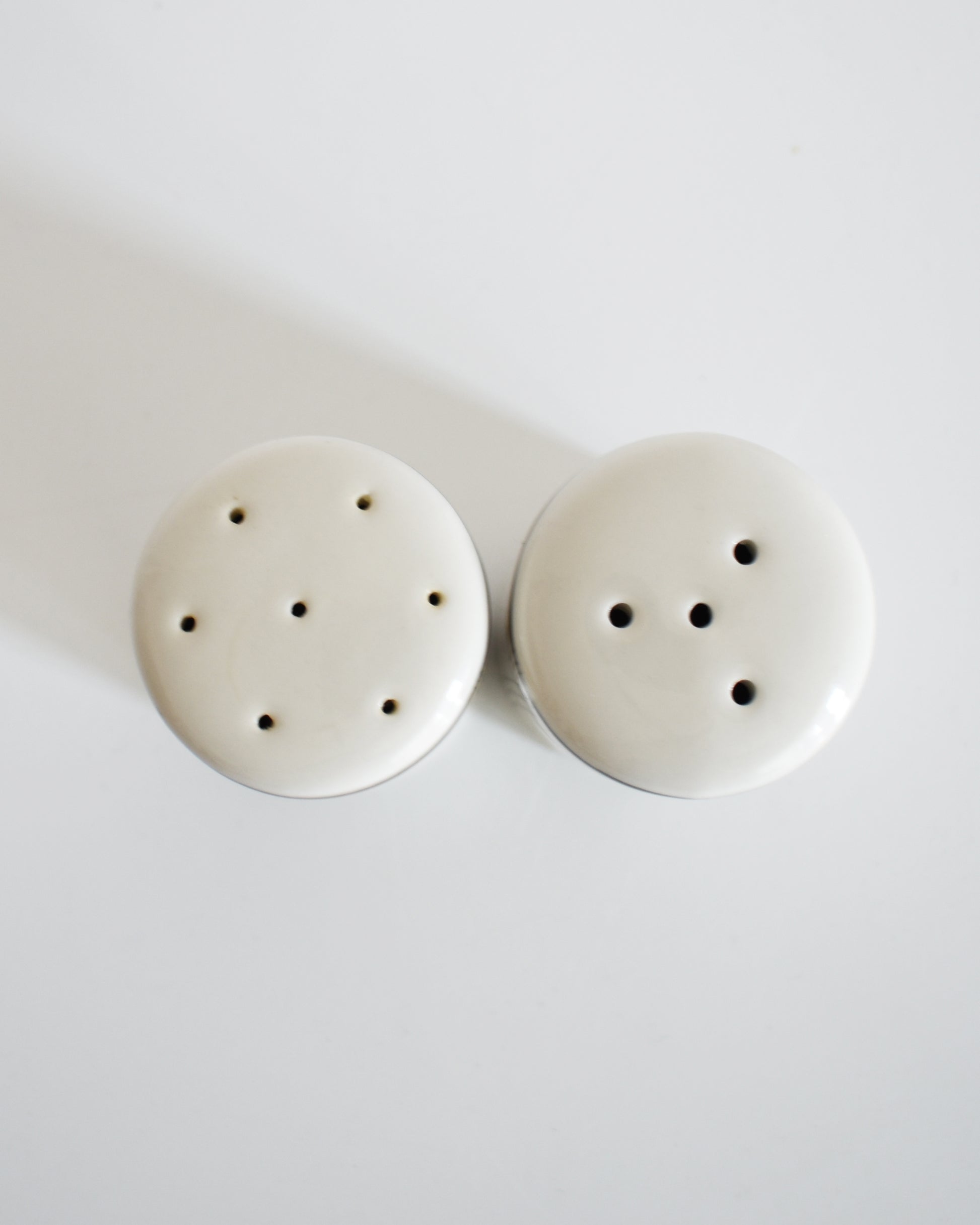 overhead shot of a set of ceramic Frank Lloyd Wright Martin House salt and pepper shakers on a white background
