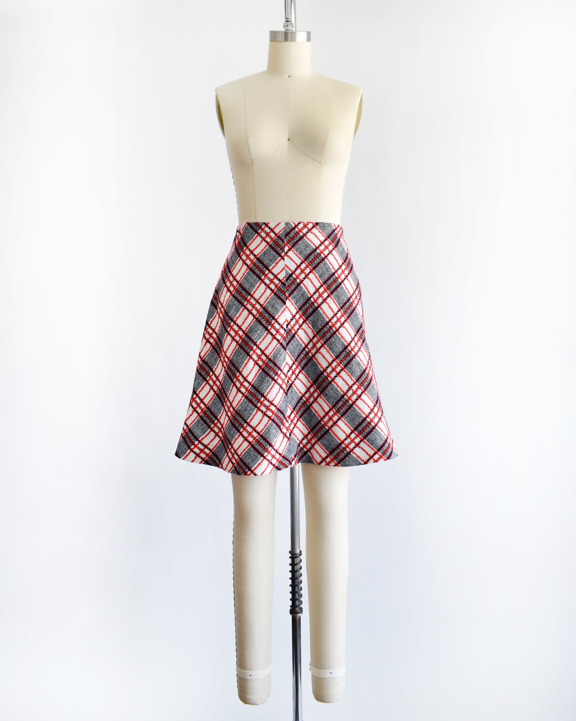 a vintage plaid skirt on a mannequin against a white background