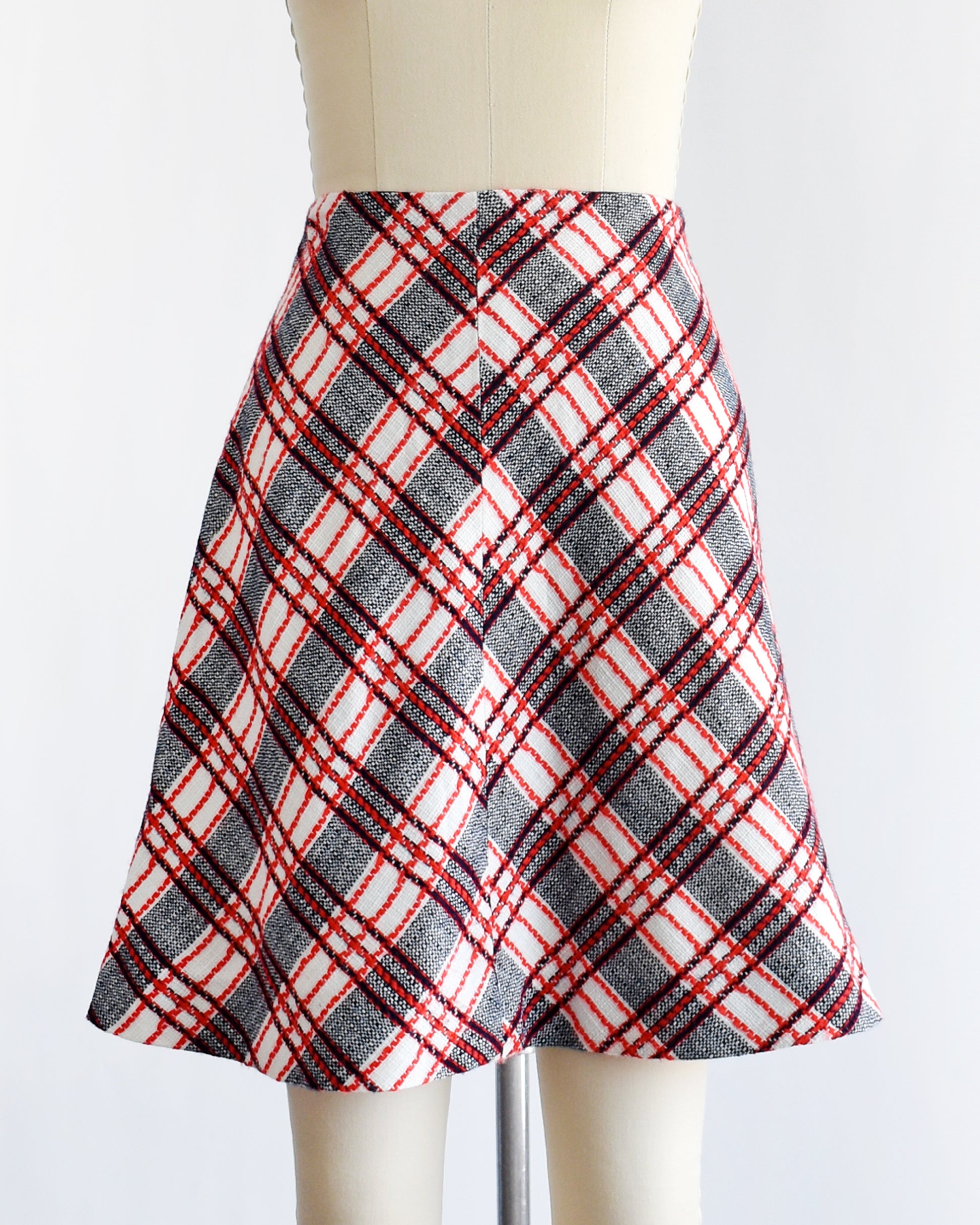 a vintage plaid skirt on a mannequin against a white background